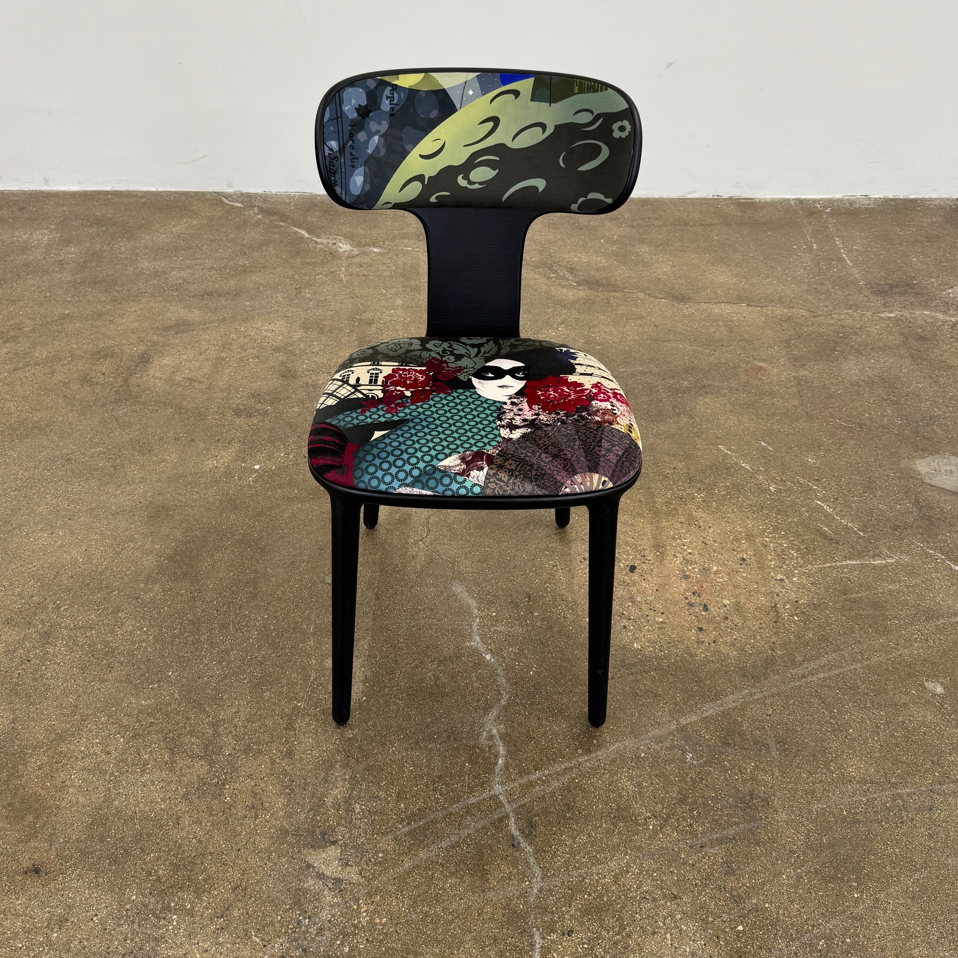 A set of six black Roche Bobois Globe Trotter Operette dining chairs, featuring patterned cushions and backs, arranged in two rows against a plain white background.