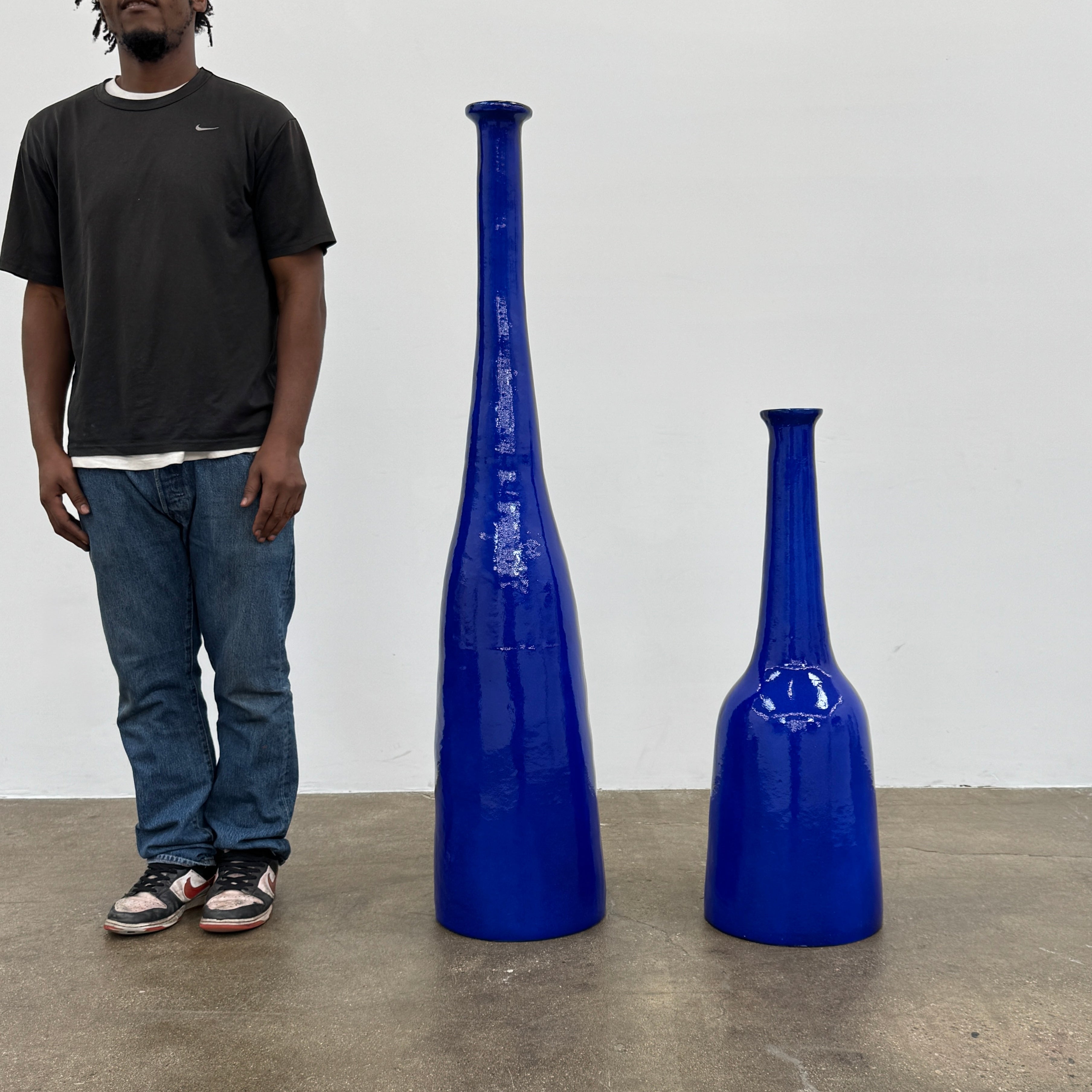 The Gervasoni In/Out Bottles, Set of 2 by Gervasoni features two glossy cobalt blue ceramic bottles of varying heights displayed side by side against a plain white background.