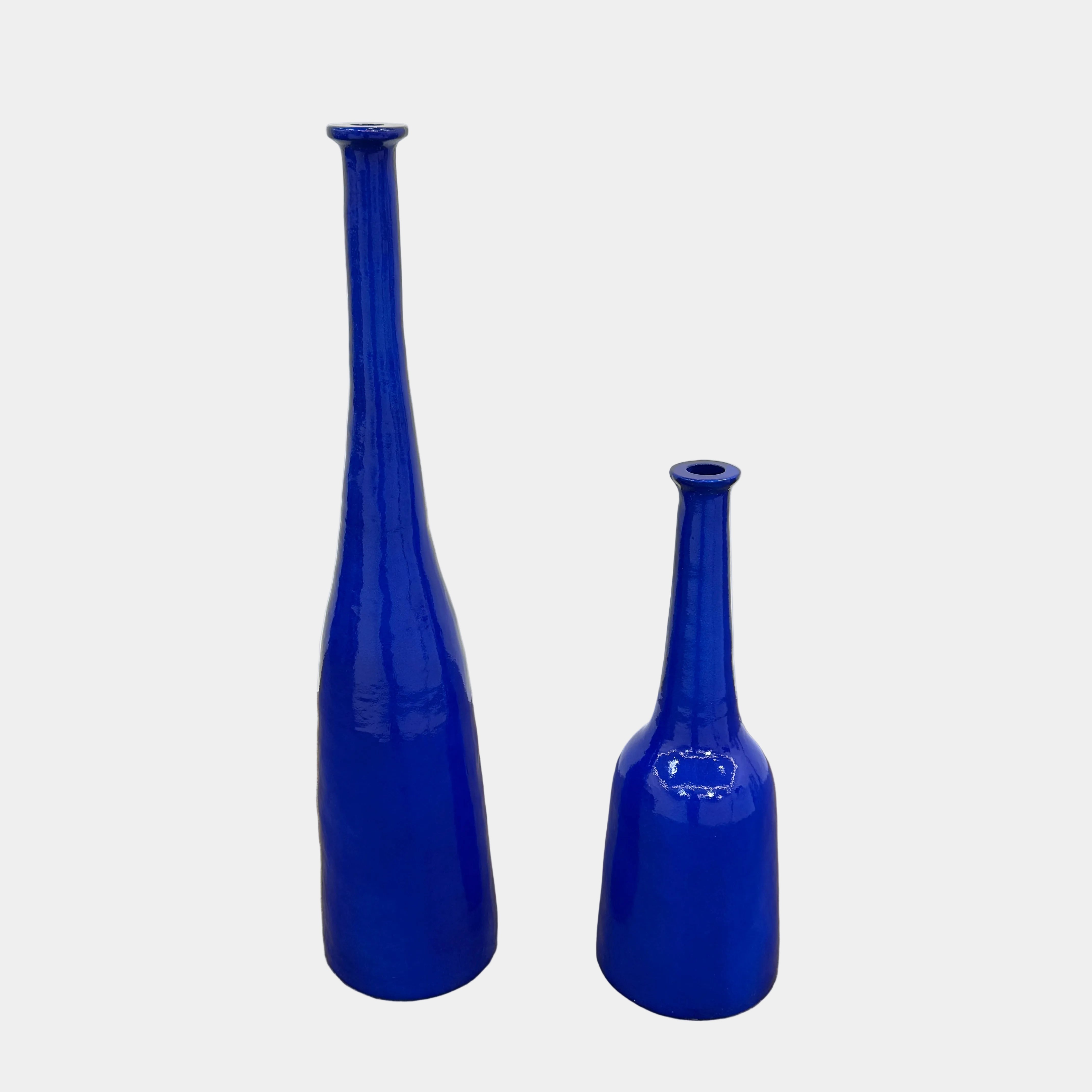 The Gervasoni In/Out Bottles, Set of 2 by Gervasoni features two glossy cobalt blue ceramic bottles of varying heights displayed side by side against a plain white background.