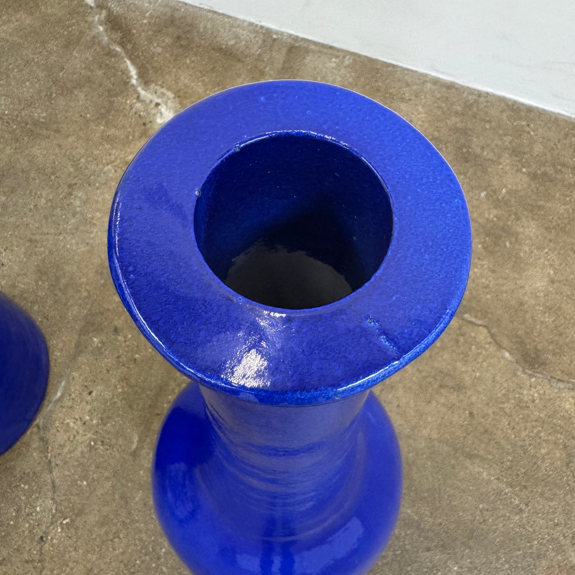 The Gervasoni In/Out Bottles, Set of 2 by Gervasoni features two glossy cobalt blue ceramic bottles of varying heights displayed side by side against a plain white background.