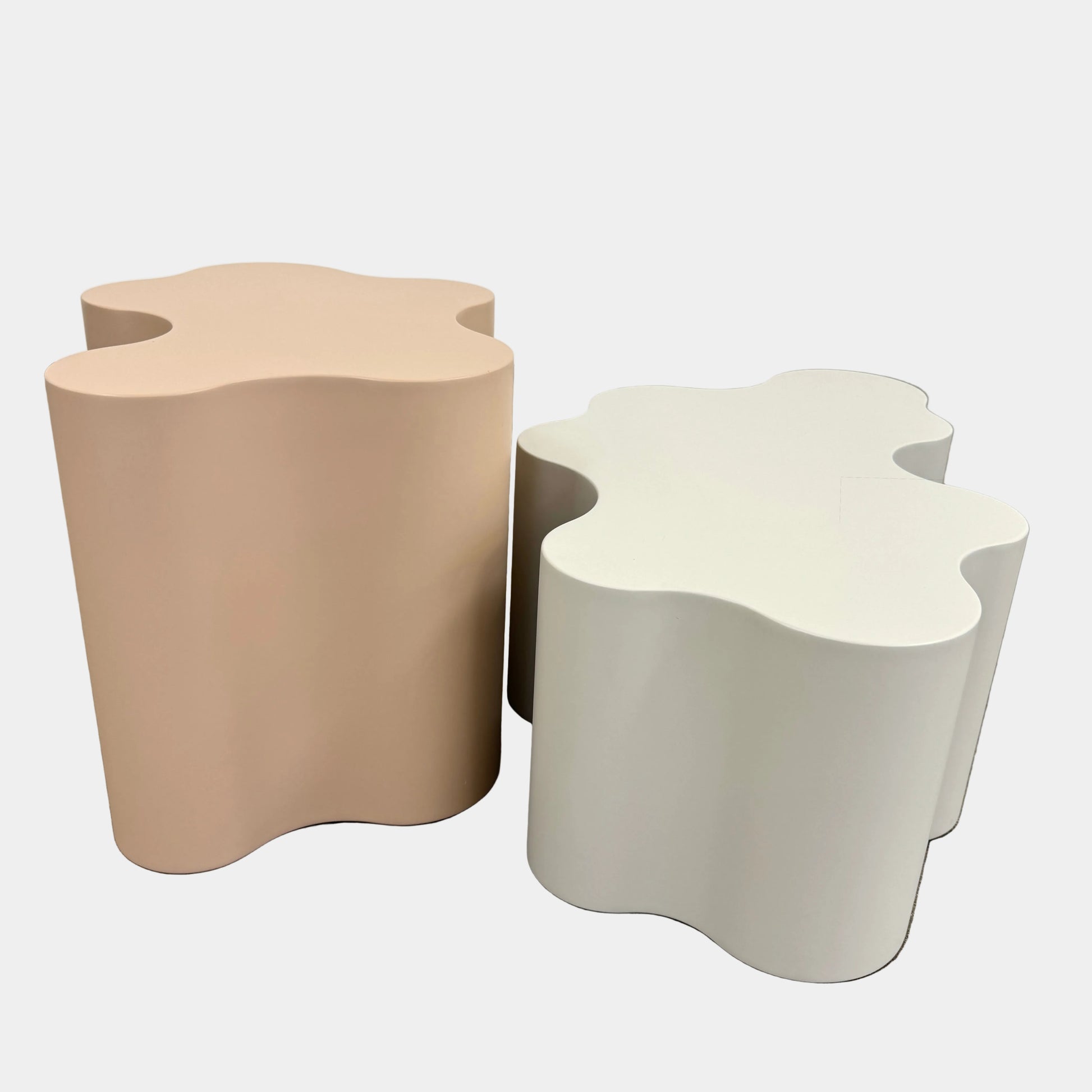 The Saba Italia Teatro Magico Table Set Grey + Nude by Saba Italia, with wavy edges and cloud shapes, sits on a polished concrete floor against a plain white wall.