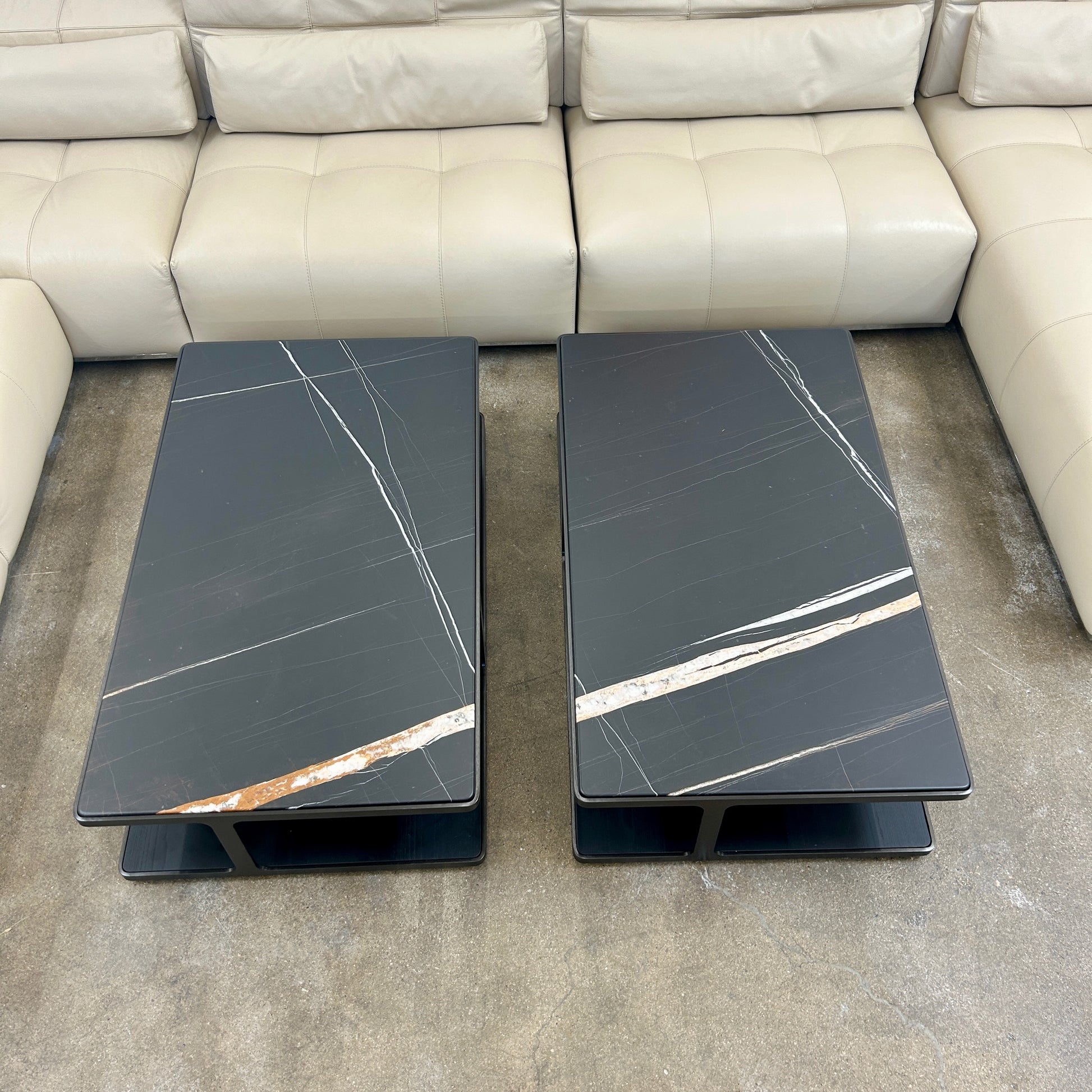 The Poliform Creek Marble Coffee Table is a rectangular Sahara Noir marble piece with a thin, horizontal design and subtle veining.