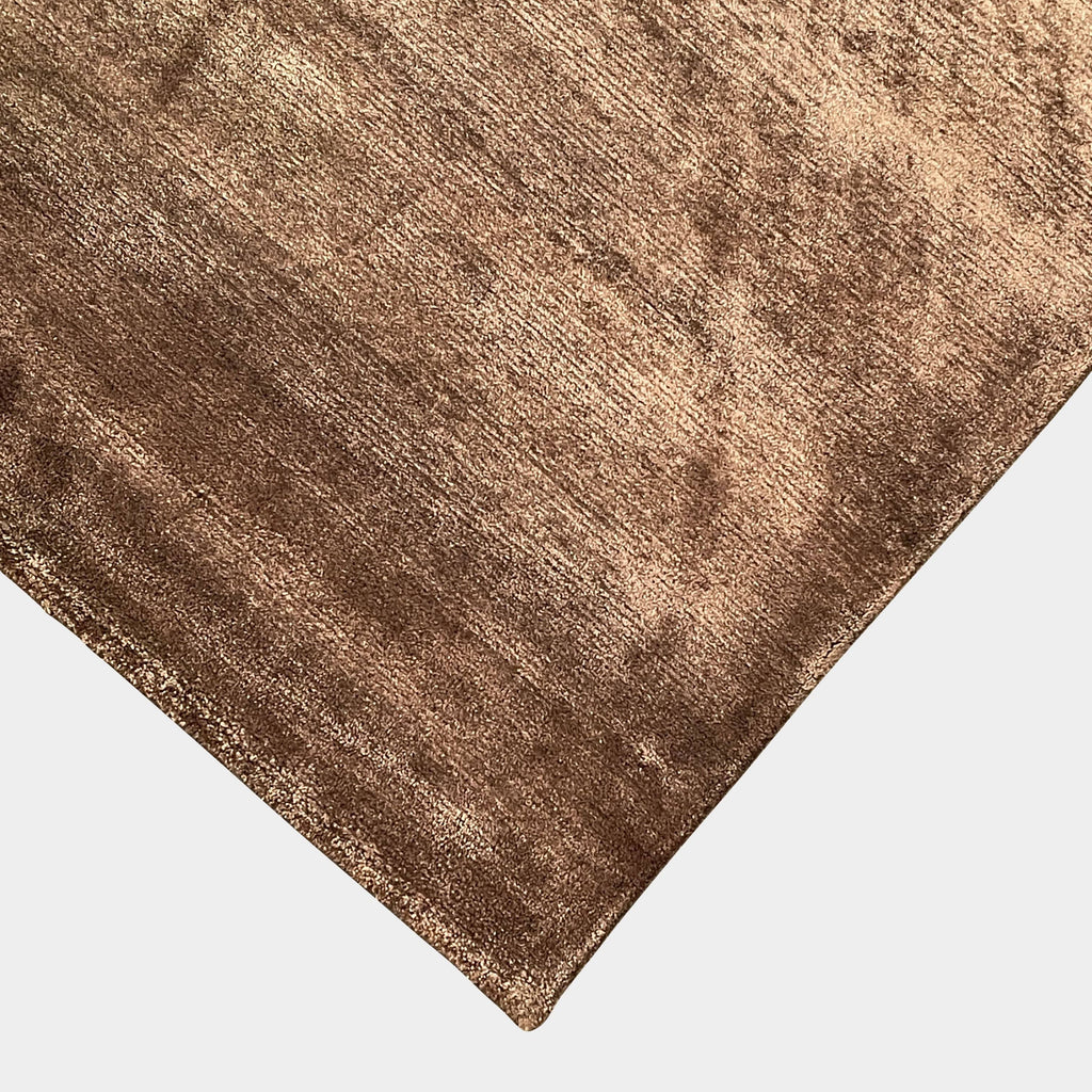 A Delinear Bamboo 8' X 10' rug laid out on a flat surface with lighting creating shadows and highlights on its surface.