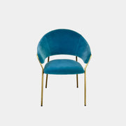 Two Pedrali Jazz Chairs by Pedrali, featuring customizable teal velvet upholstery and gold metal legs, sit side by side on a concrete floor against a white wall, highlighting their stylish steel structure.
