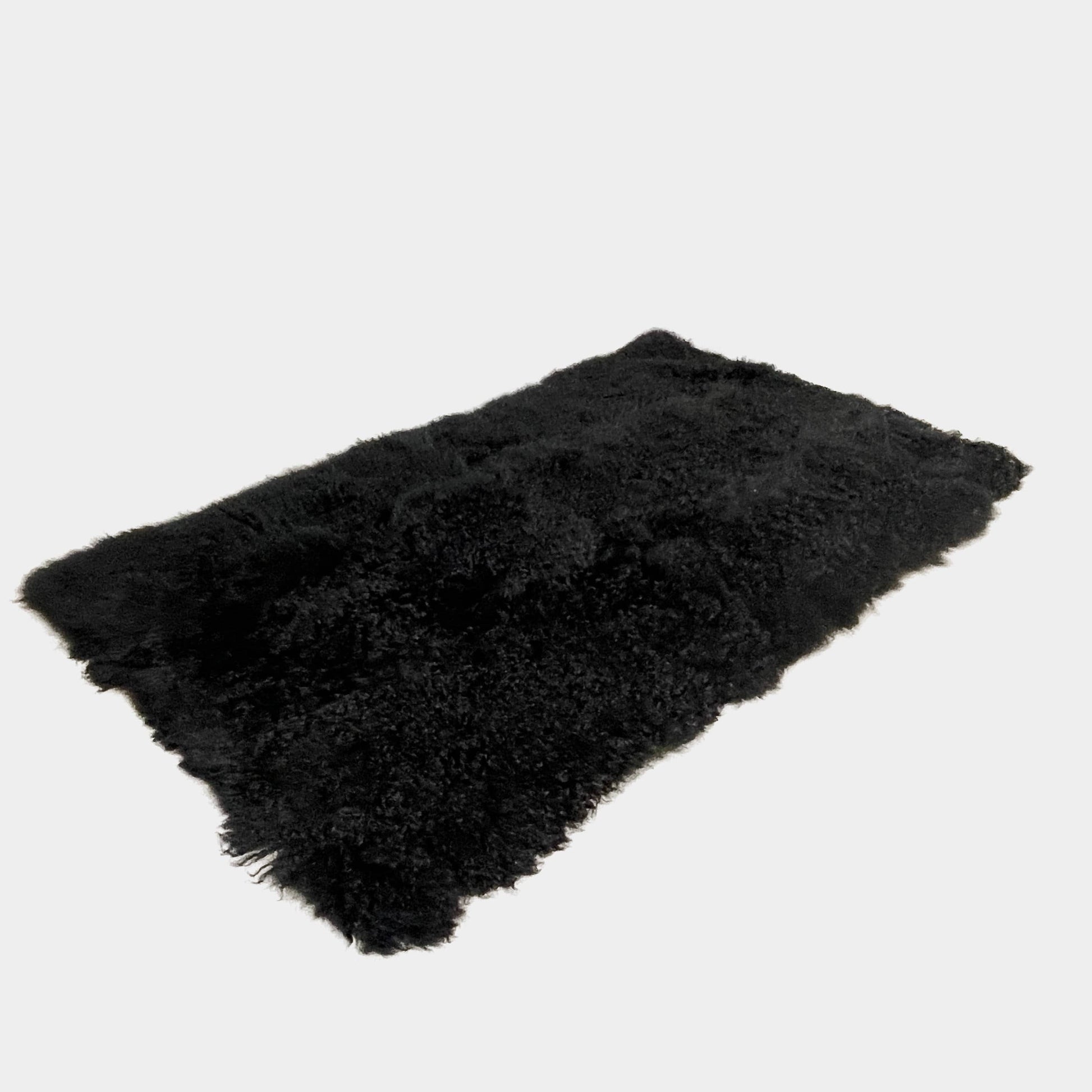 Black Icelandic Sheepskin 5' x 7' rug with a shaggy appearance against a white background.