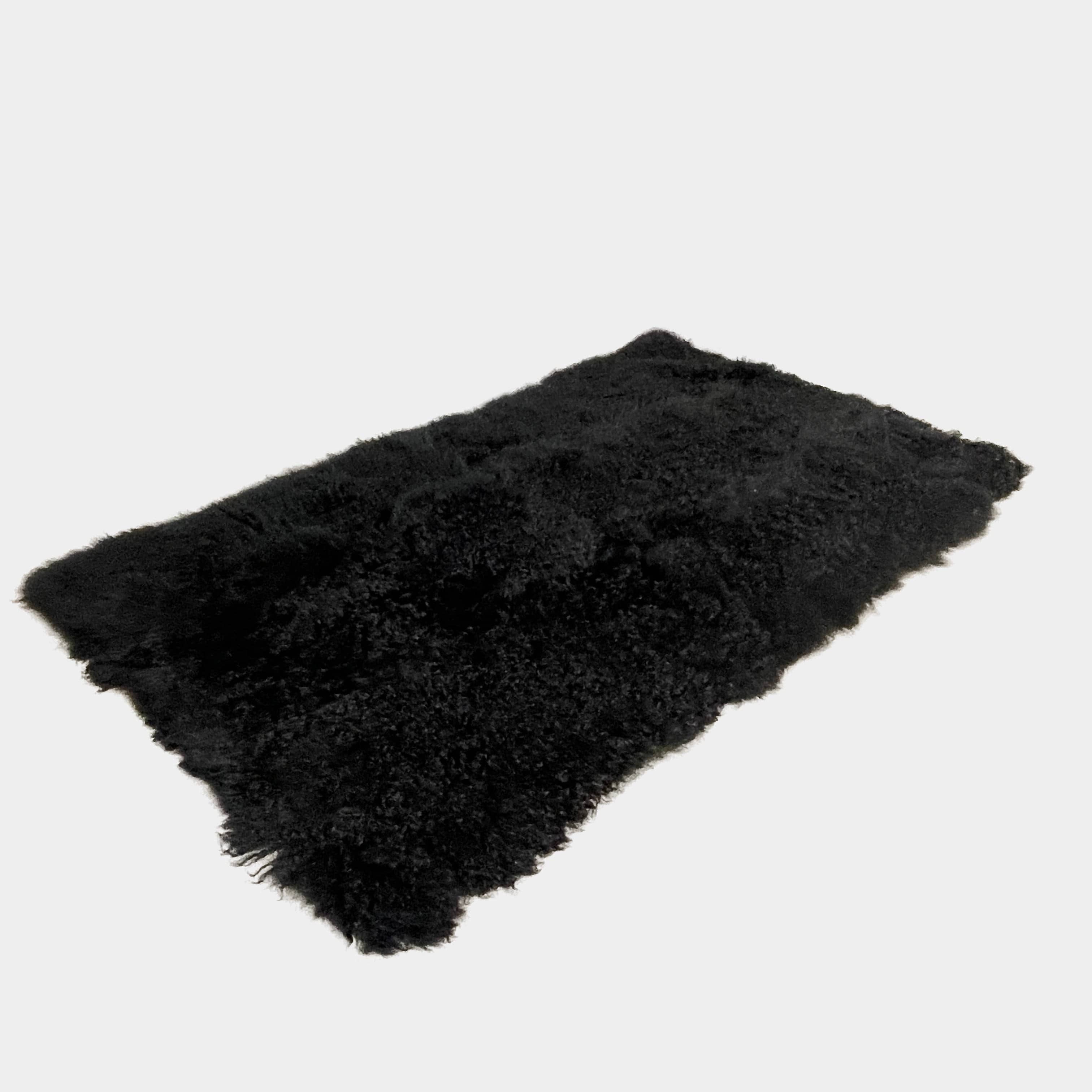 Black Icelandic Sheepskin 5' x 7' rug with a shaggy appearance against a white background.