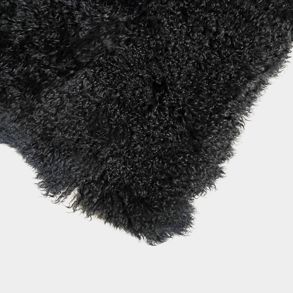 Black Icelandic Sheepskin 5' x 7' rug with a shaggy appearance against a white background.