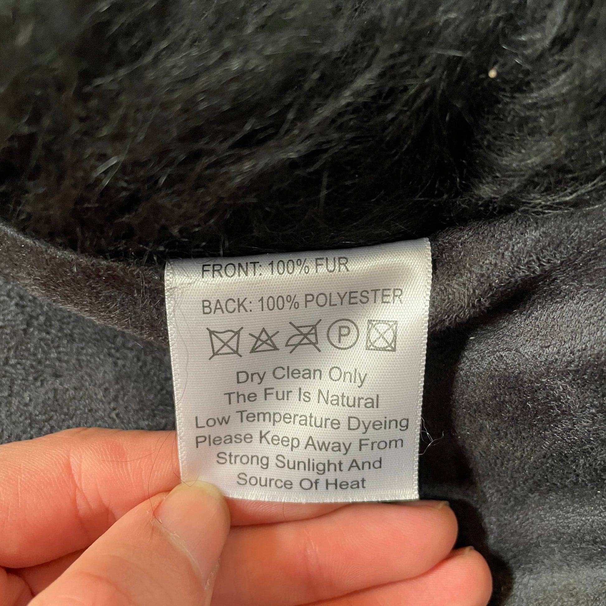 Black Icelandic Sheepskin 5' x 7' rug with a shaggy appearance against a white background.