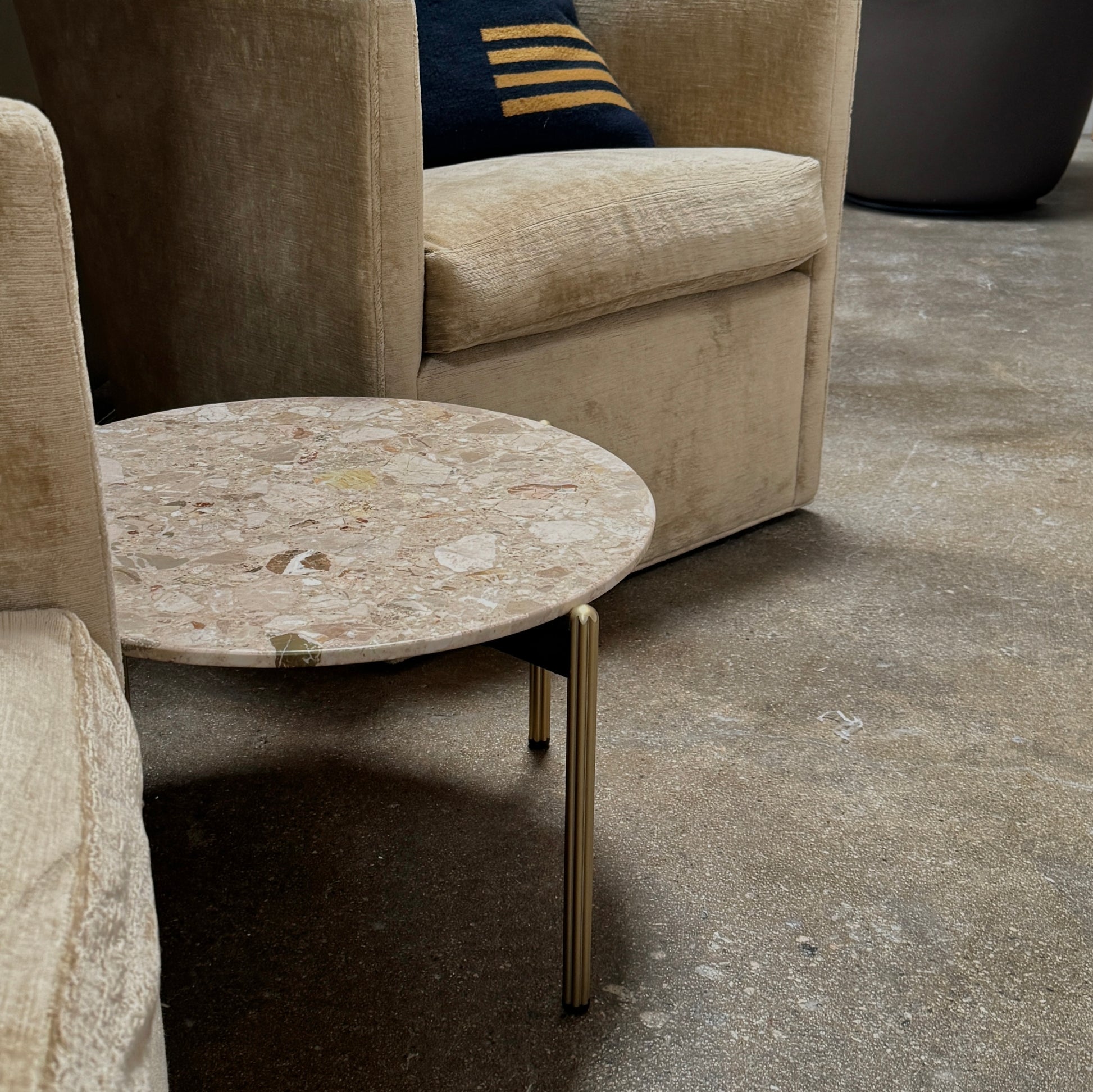 The Pedrali Blume Side Table features a round top and elegant gold legs, offering a stylish addition to any room.