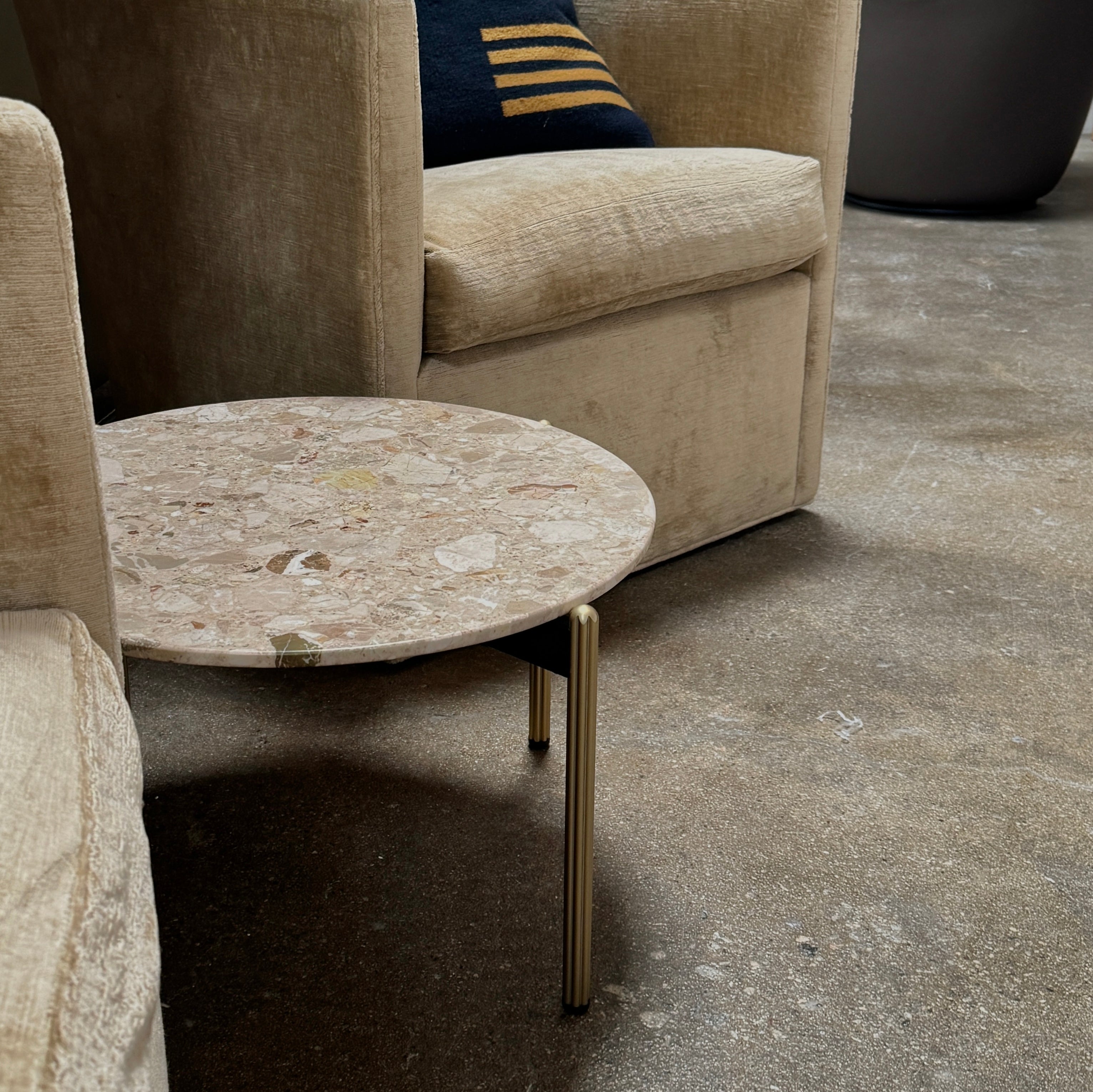 The Pedrali Blume Side Table features a round top and elegant gold legs, offering a stylish addition to any room.