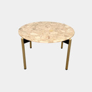 The Pedrali Blume Side Table features a round top and elegant gold legs, offering a stylish addition to any room.