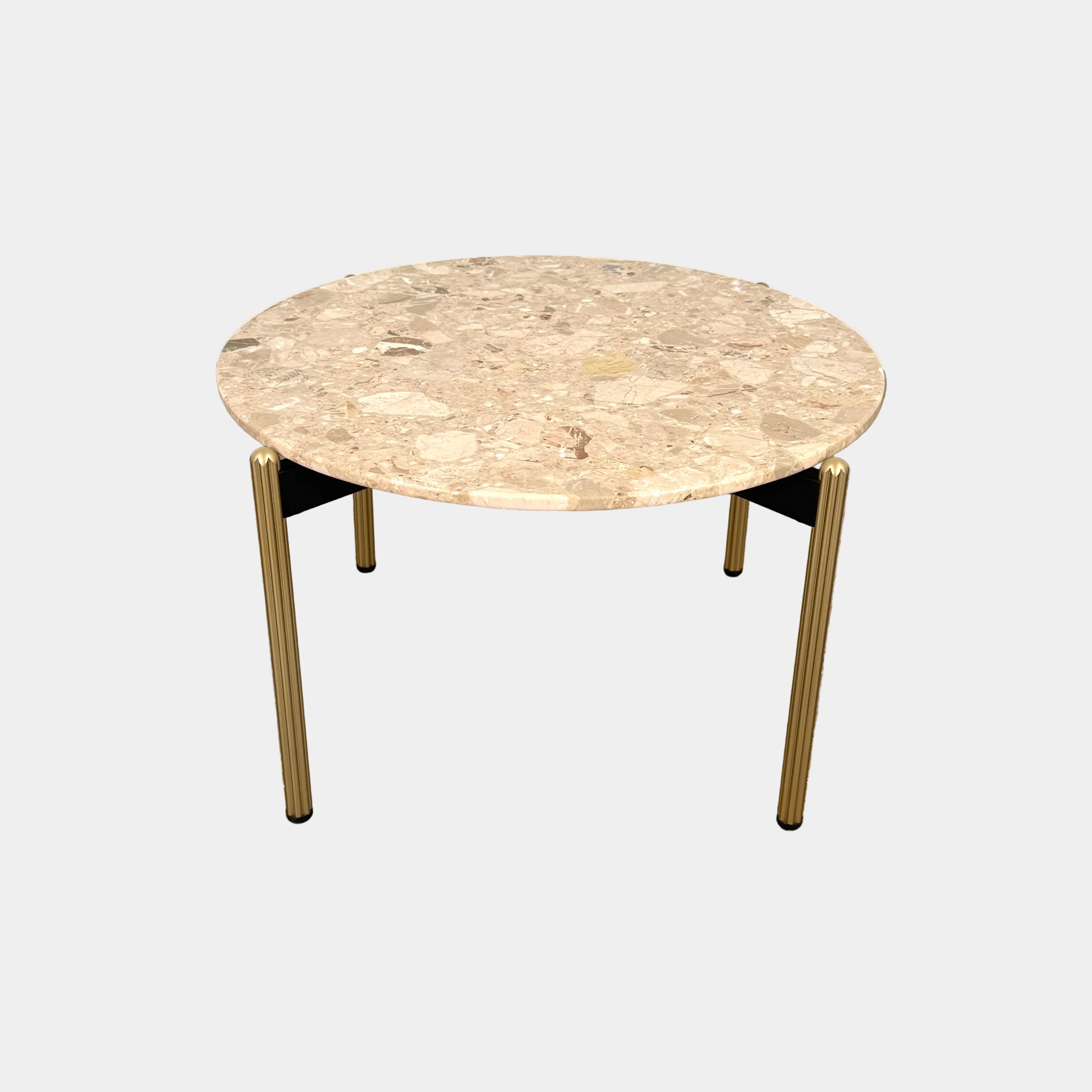 The Pedrali Blume Side Table features a round top and elegant gold legs, offering a stylish addition to any room.
