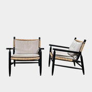 Two hand-crafted Flexform Tessa Lounge Chairs with black frames and neutral-tone cushions on a white background.