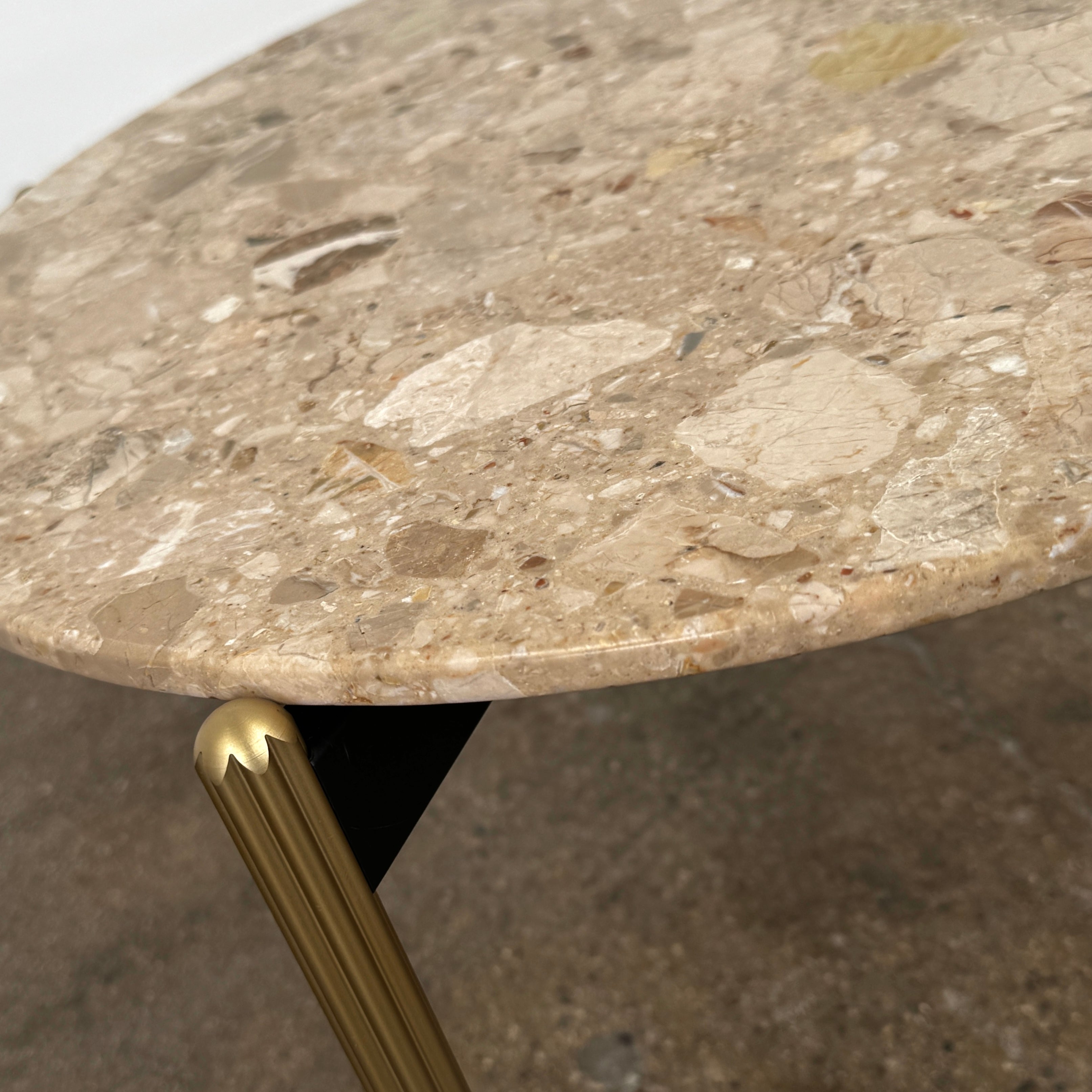 The Pedrali Blume Side Table features a round top and elegant gold legs, offering a stylish addition to any room.