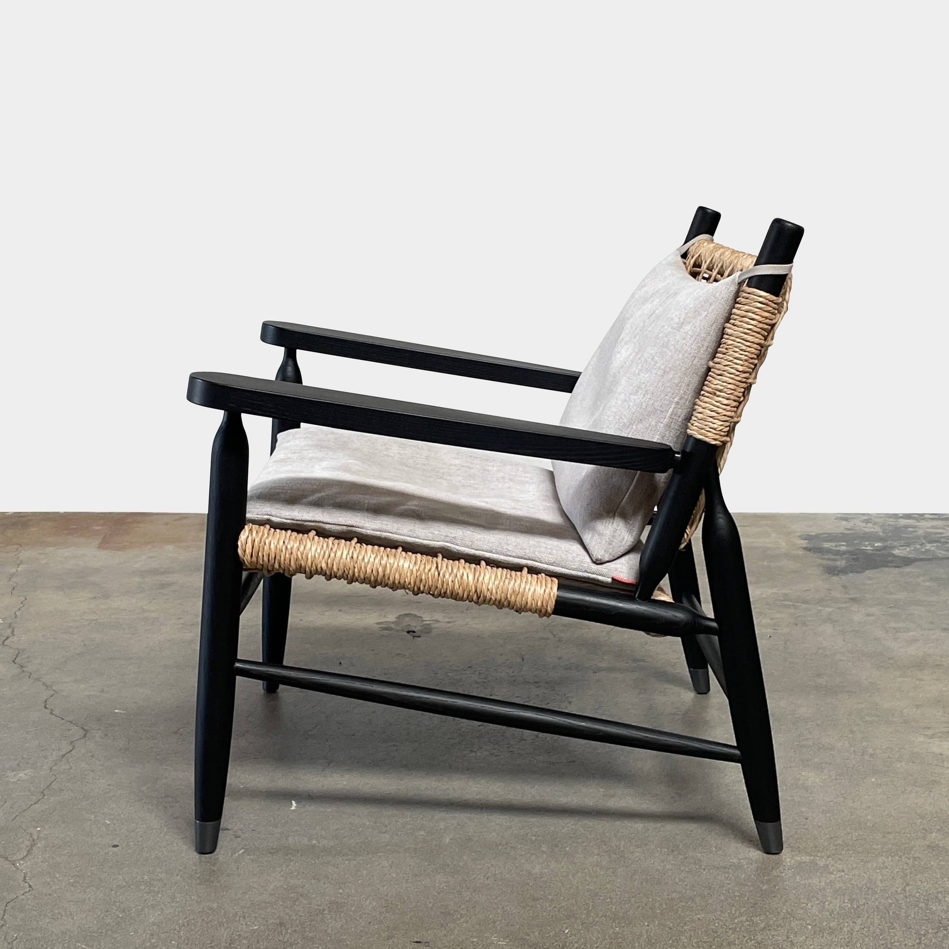 Two hand-crafted Flexform Tessa Lounge Chairs with black frames and neutral-tone cushions on a white background.