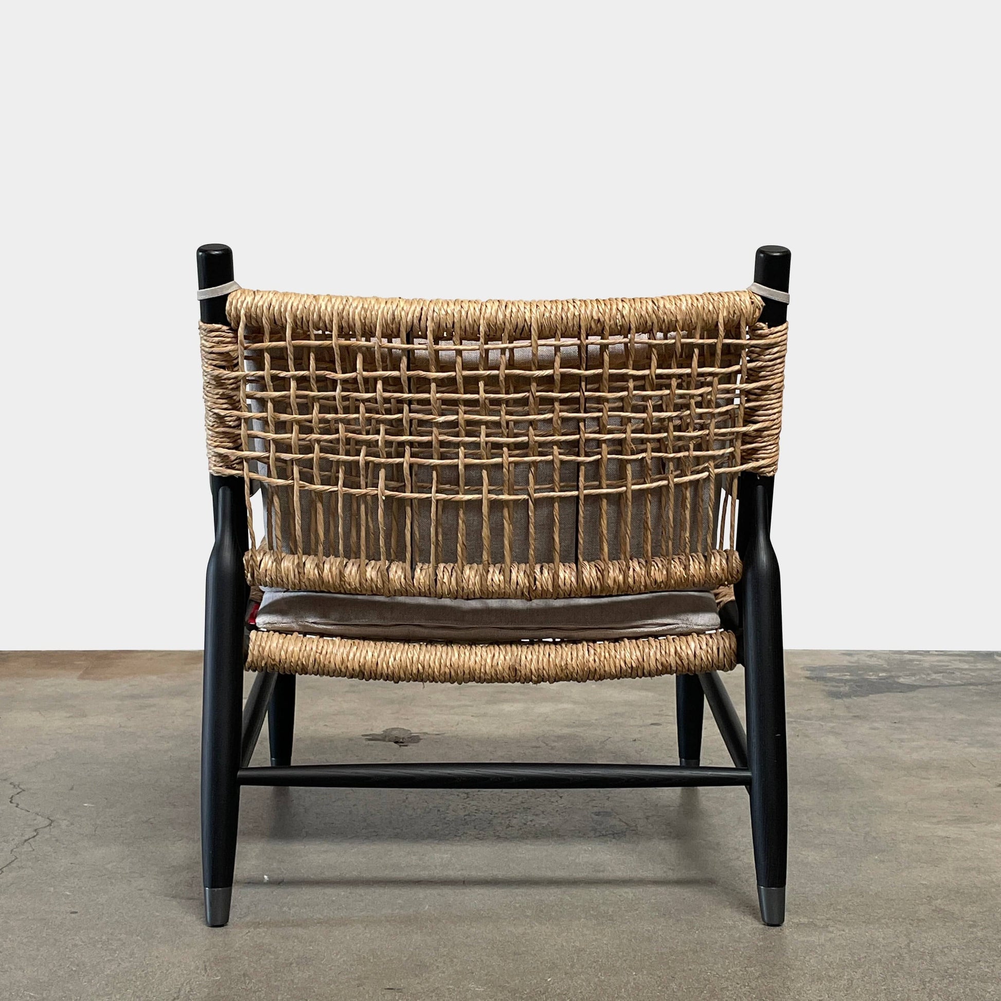 Two hand-crafted Flexform Tessa Lounge Chairs with black frames and neutral-tone cushions on a white background.