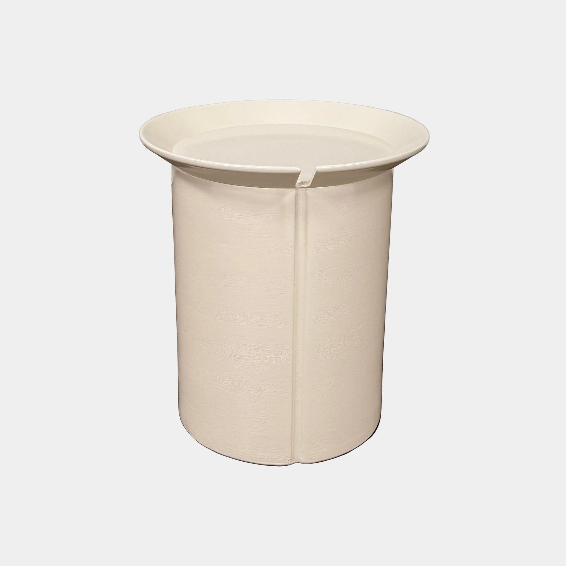 The Gervasoni Brise 43 Side Table by Gervasoni features a beige, cylindrical shape with a wide, subtly flared rim and a vertical seam, evoking Art Nouveau influences, shown against a plain white background.