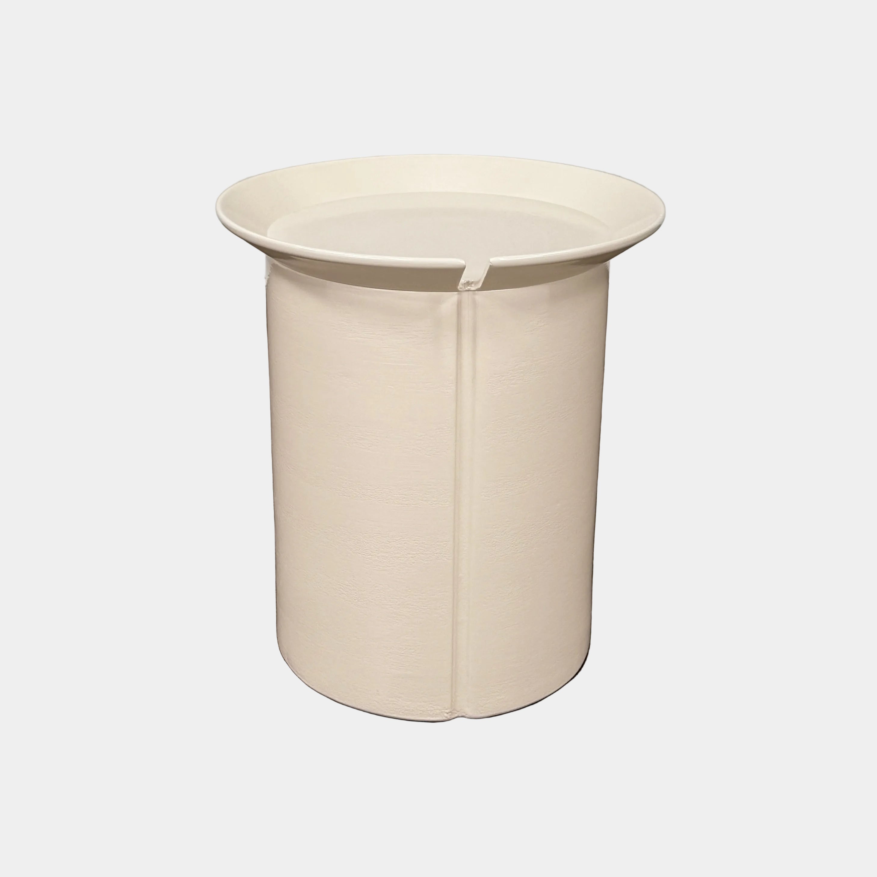 The Gervasoni Brise 43 Side Table by Gervasoni features a beige, cylindrical shape with a wide, subtly flared rim and a vertical seam, evoking Art Nouveau influences, shown against a plain white background.