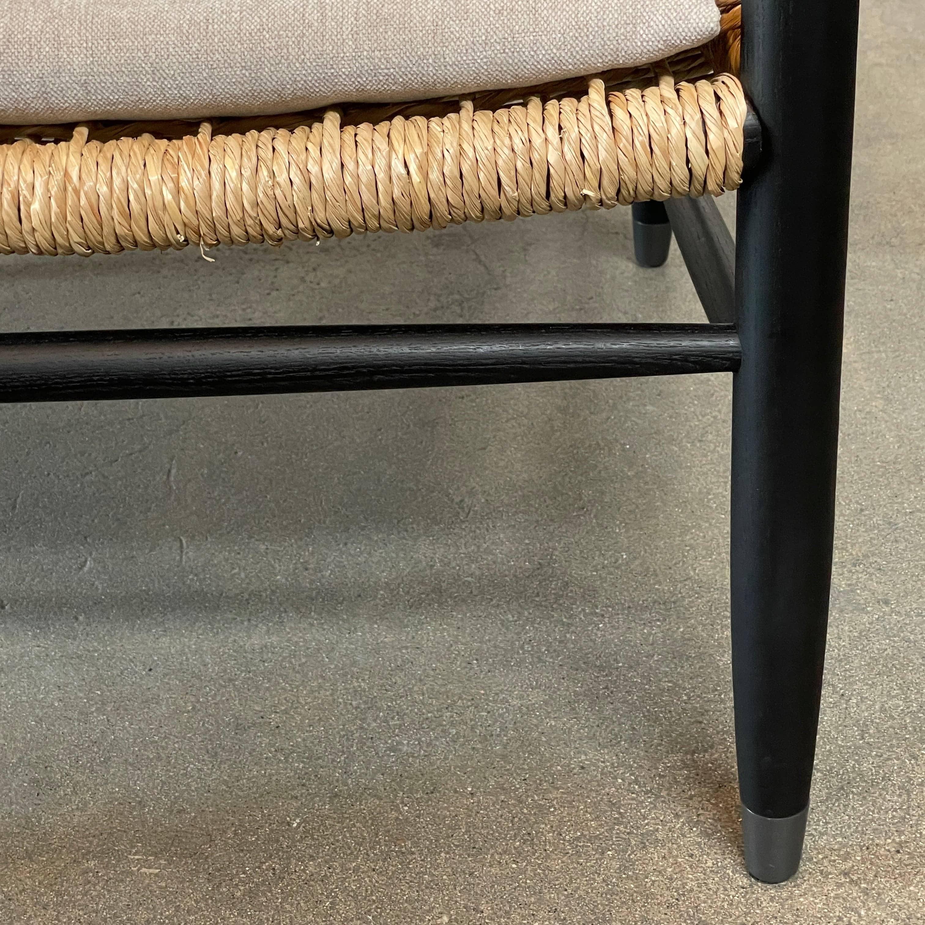 Two hand-crafted Flexform Tessa Lounge Chairs with black frames and neutral-tone cushions on a white background.