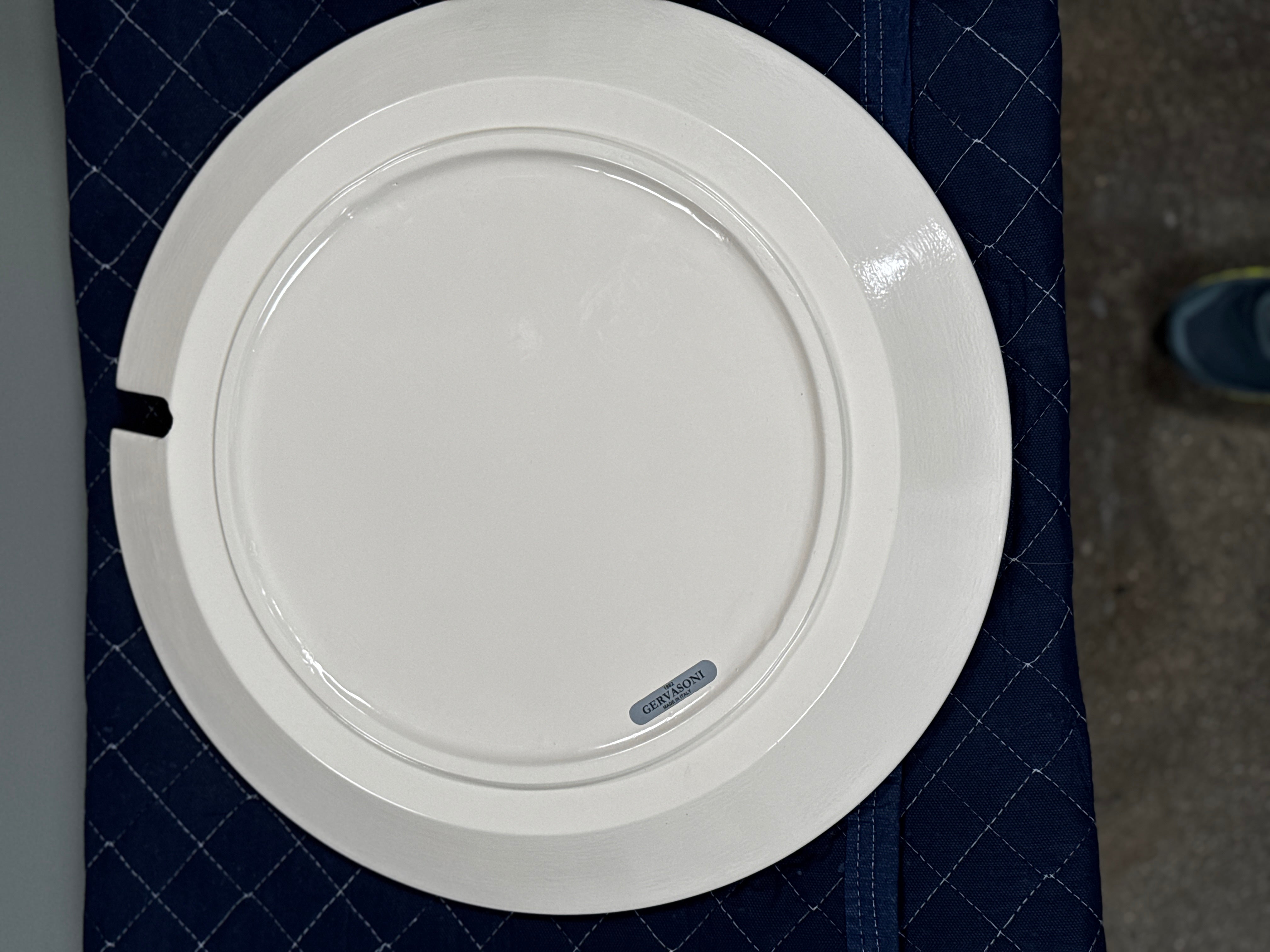 The Gervasoni Brise 43 Side Table by Gervasoni features a beige, cylindrical shape with a wide, subtly flared rim and a vertical seam, evoking Art Nouveau influences, shown against a plain white background.