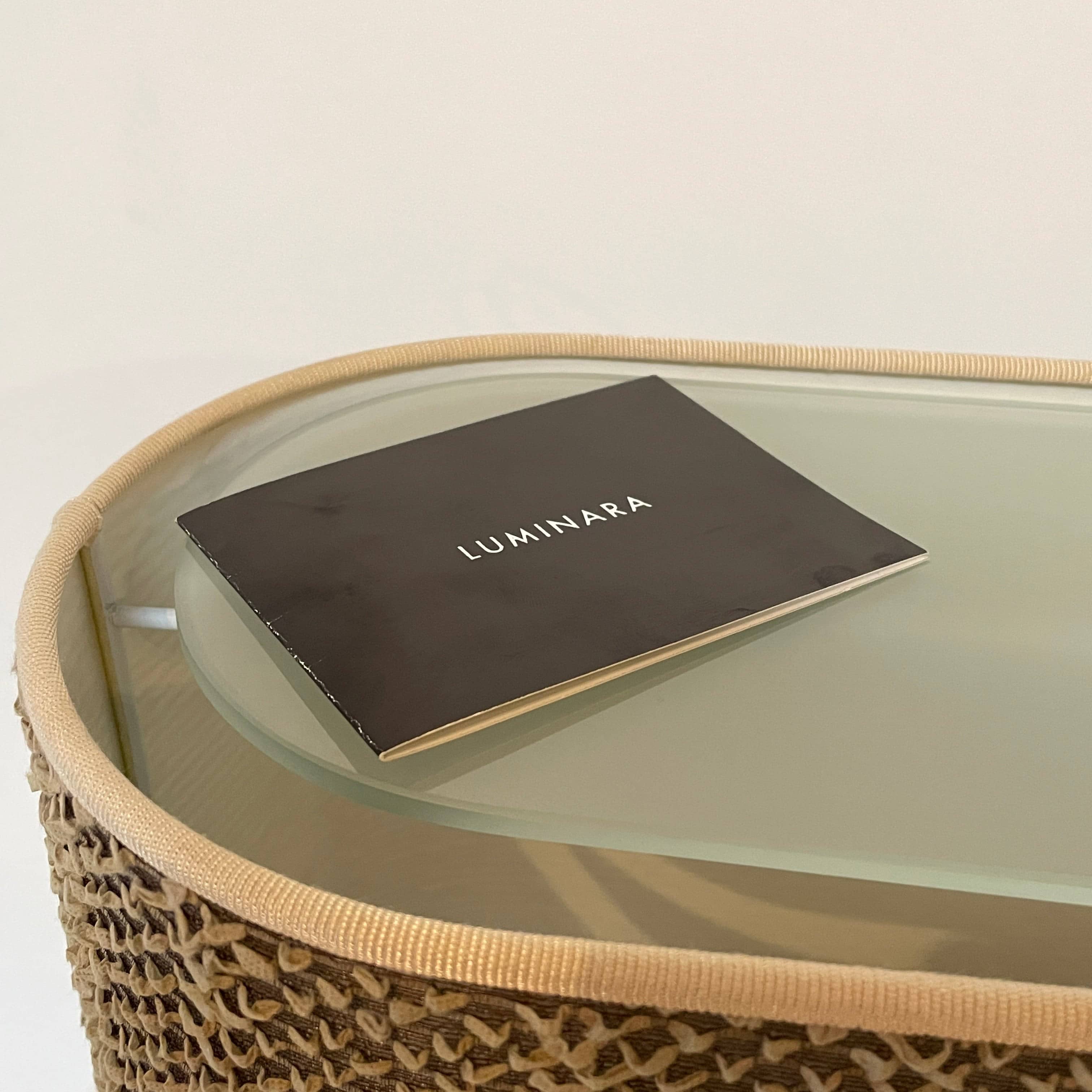 Two-tiered, textured fabric lampshade with a loop finial on a white background for the Luminara Dabliu Table Light by Luminara.