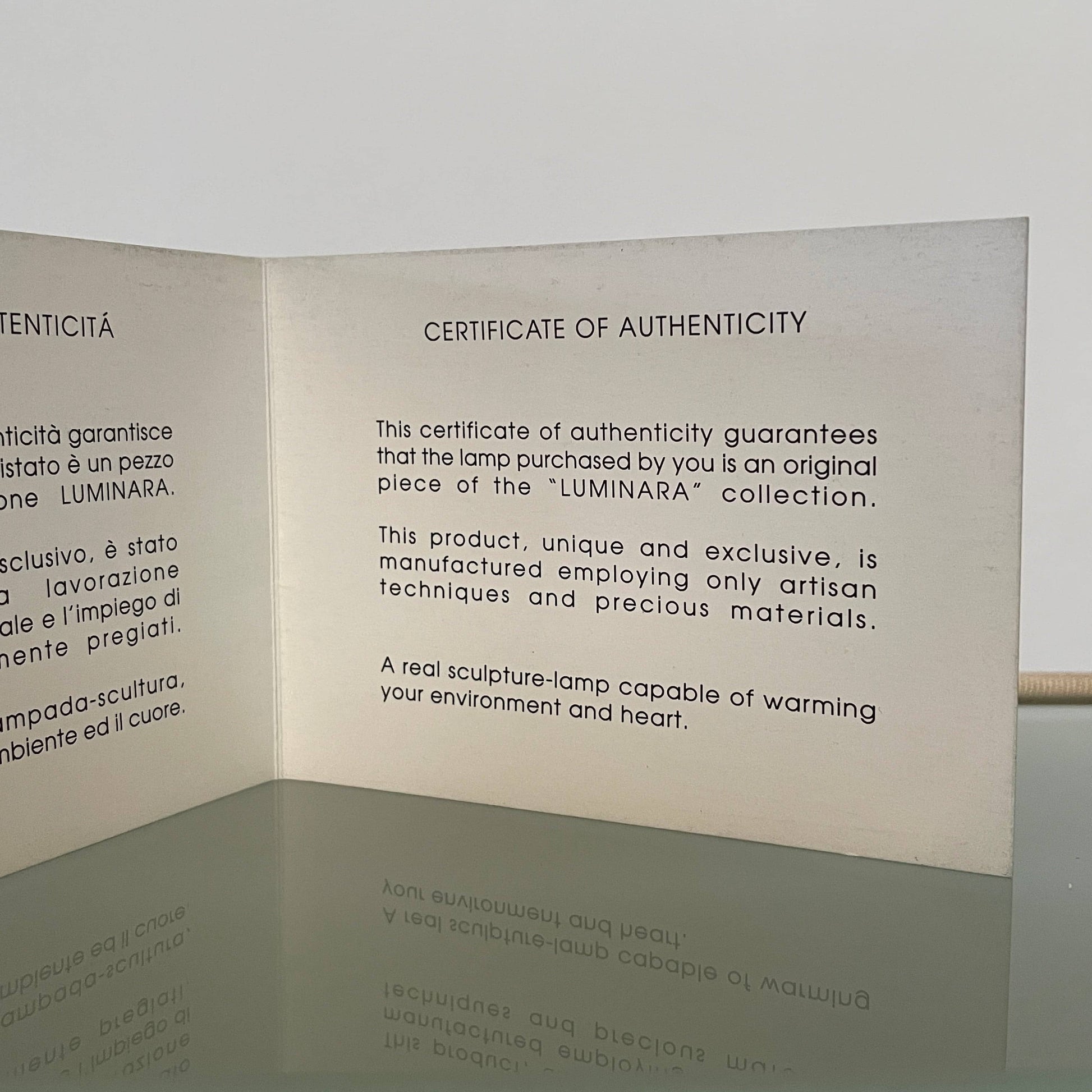 Two-tiered, textured fabric lampshade with a loop finial on a white background for the Luminara Dabliu Table Light by Luminara.