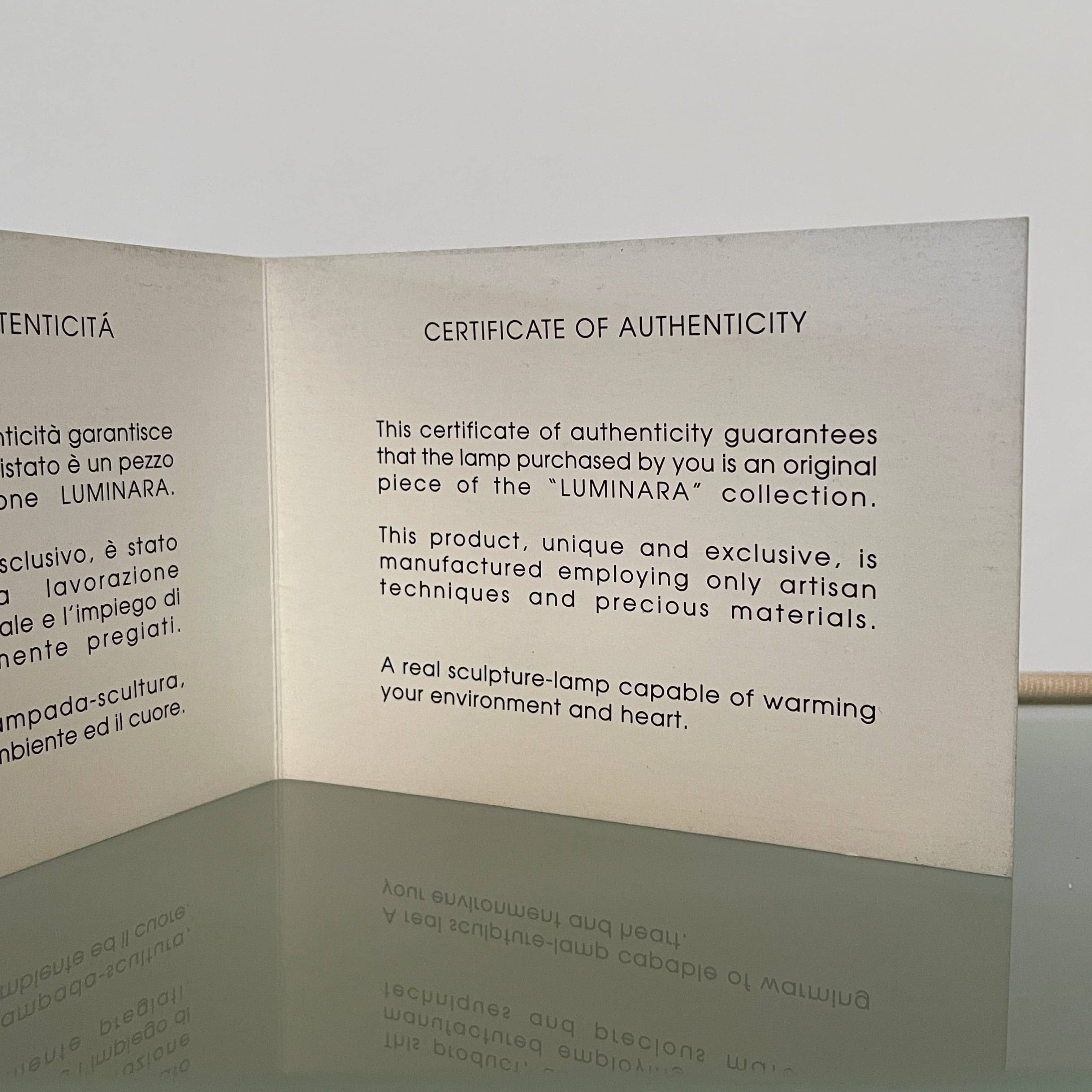 Two-tiered, textured fabric lampshade with a loop finial on a white background for the Luminara Dabliu Table Light by Luminara.