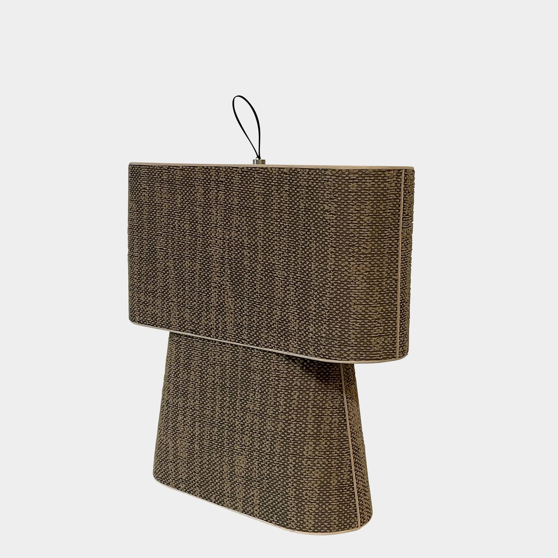 Two-tiered, textured fabric lampshade with a loop finial on a white background for the Luminara Dabliu Table Light by Luminara.