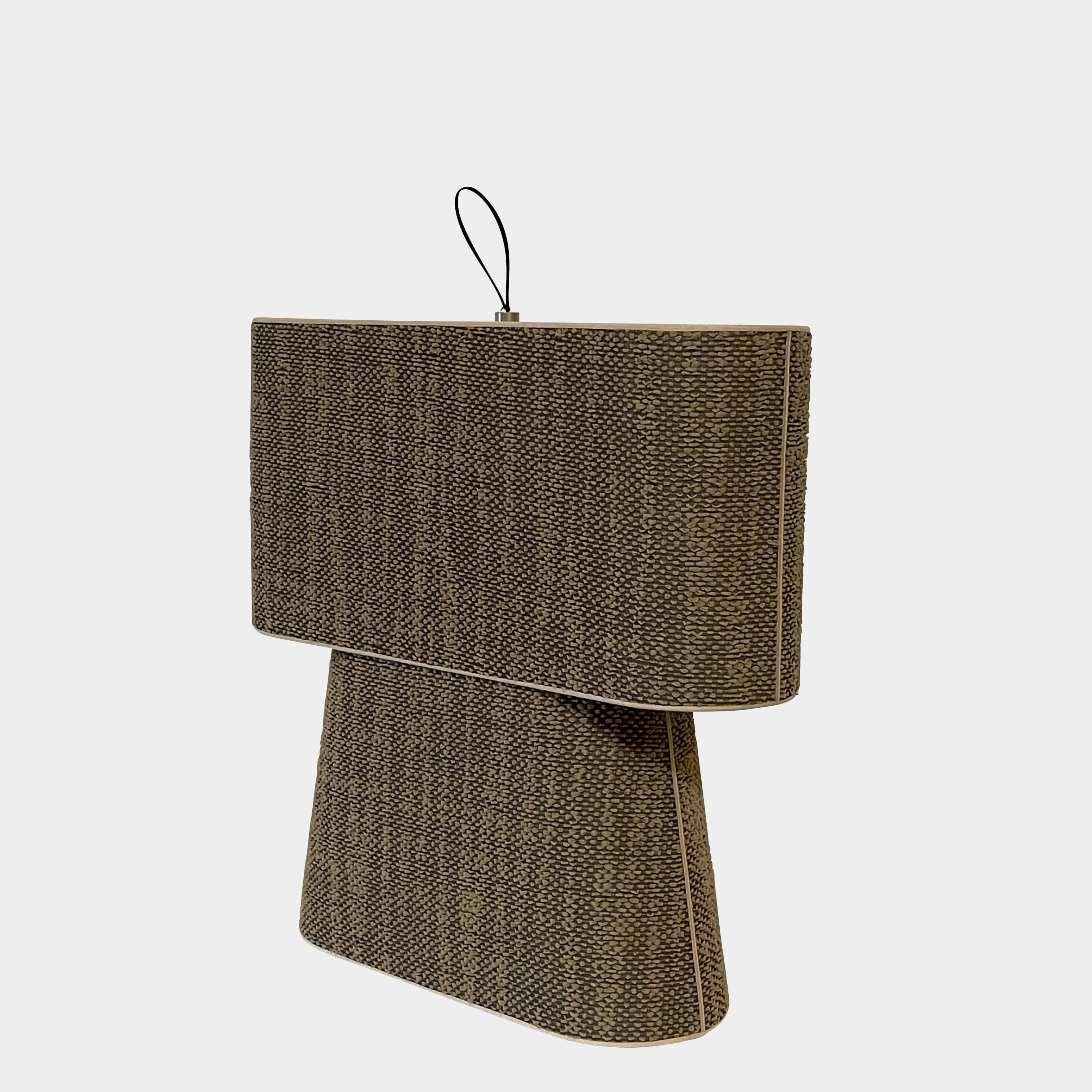 Two-tiered, textured fabric lampshade with a loop finial on a white background for the Luminara Dabliu Table Light by Luminara.