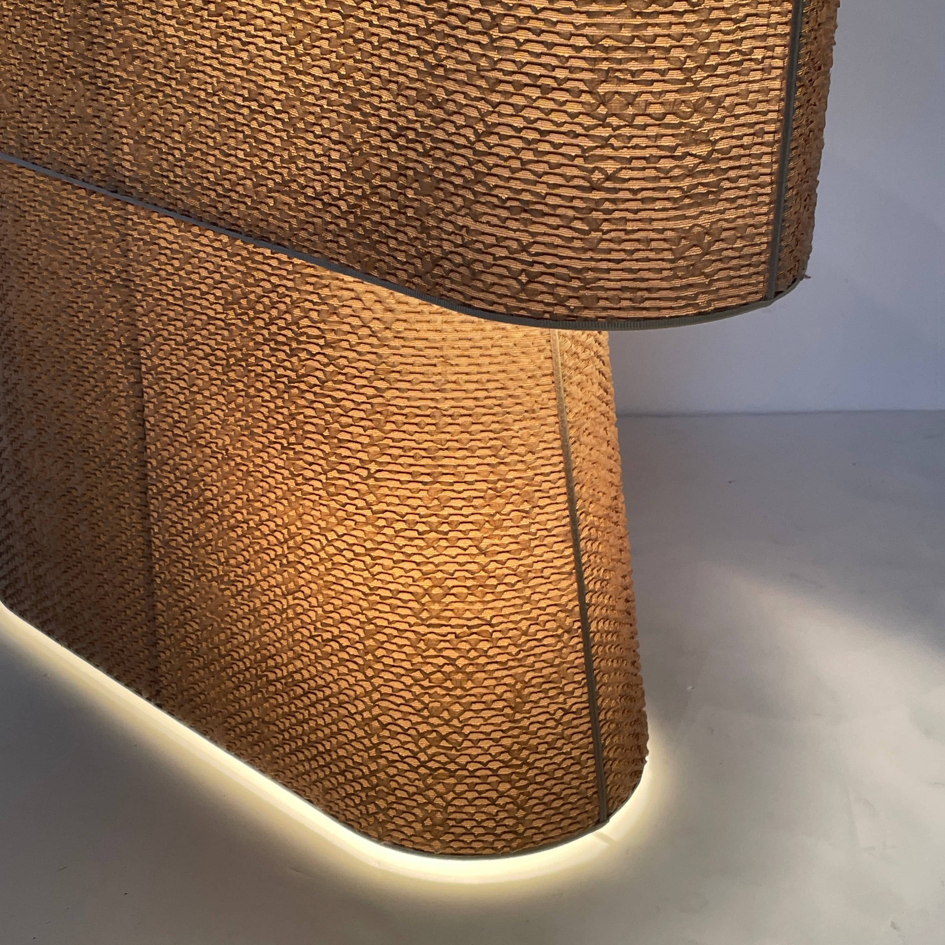 Two-tiered, textured fabric lampshade with a loop finial on a white background for the Luminara Dabliu Table Light by Luminara.