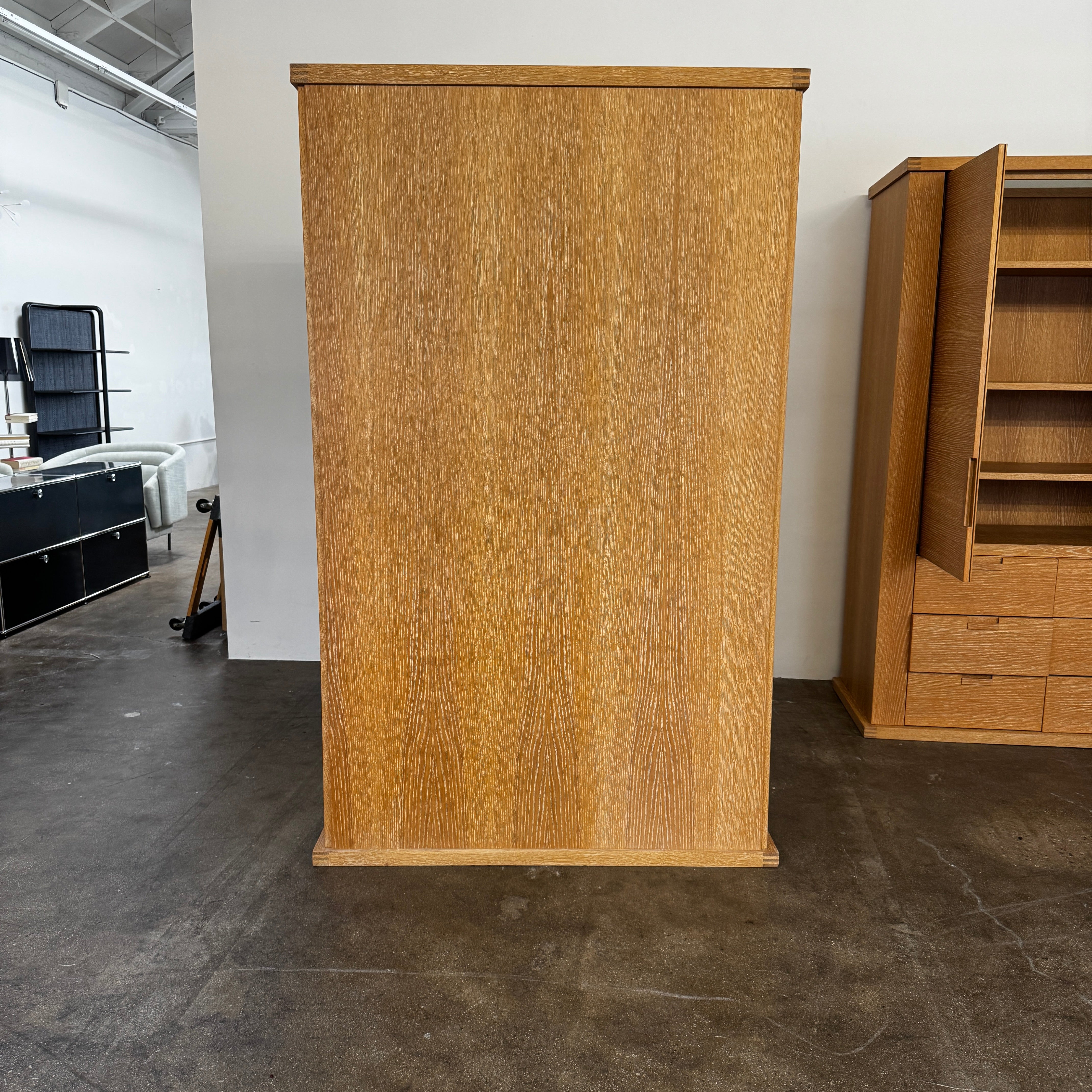 The Maxalto Apta Storage Unit by Maxalto features two vertical doors above and four bottom drawers in two rows, providing versatile storage with convenient shelves and drawers.