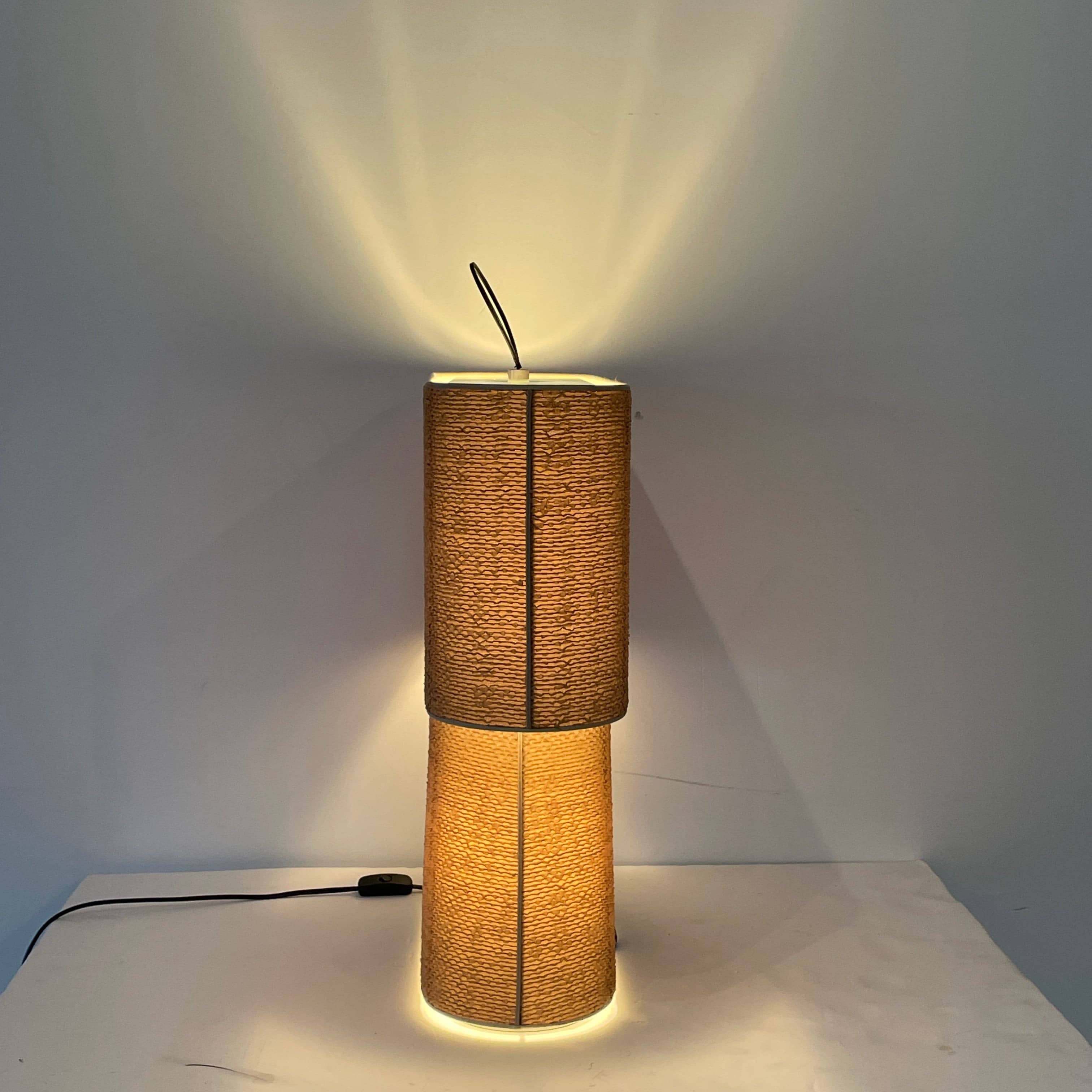 Two-tiered, textured fabric lampshade with a loop finial on a white background for the Luminara Dabliu Table Light by Luminara.