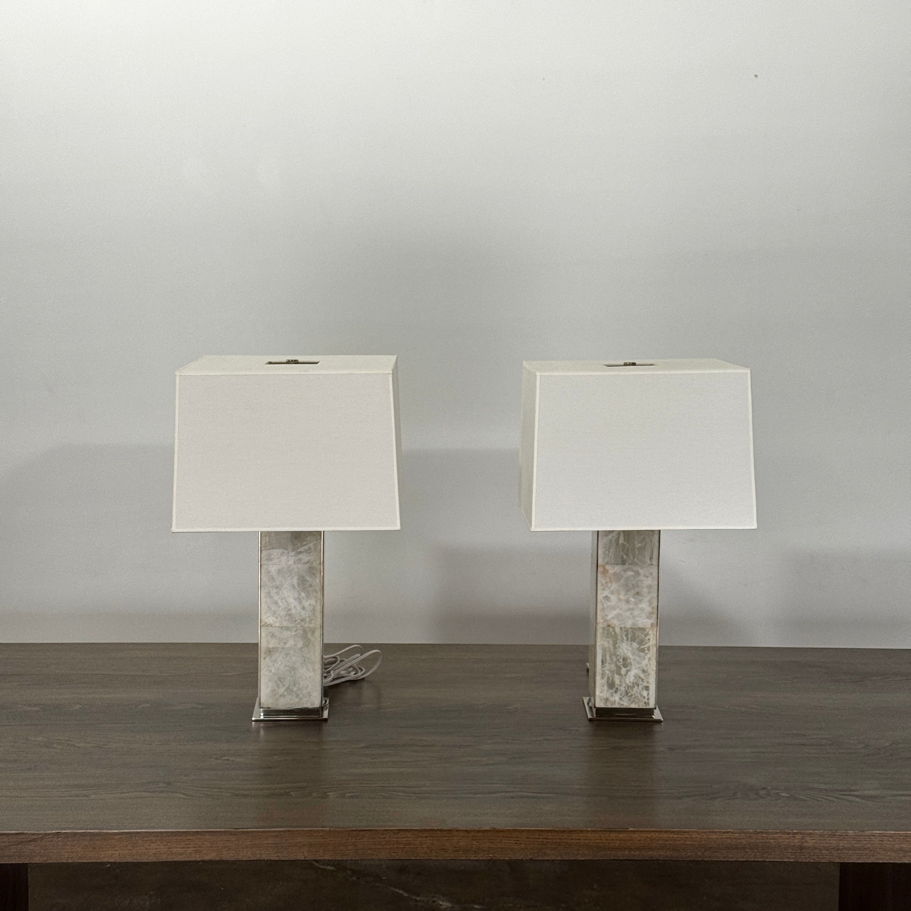 The Visual Comfort Ellis Quartz Table Lamp by Ralph Lauren features a rectangular white shade and a translucent, textured quartz base, shown against a plain white background.