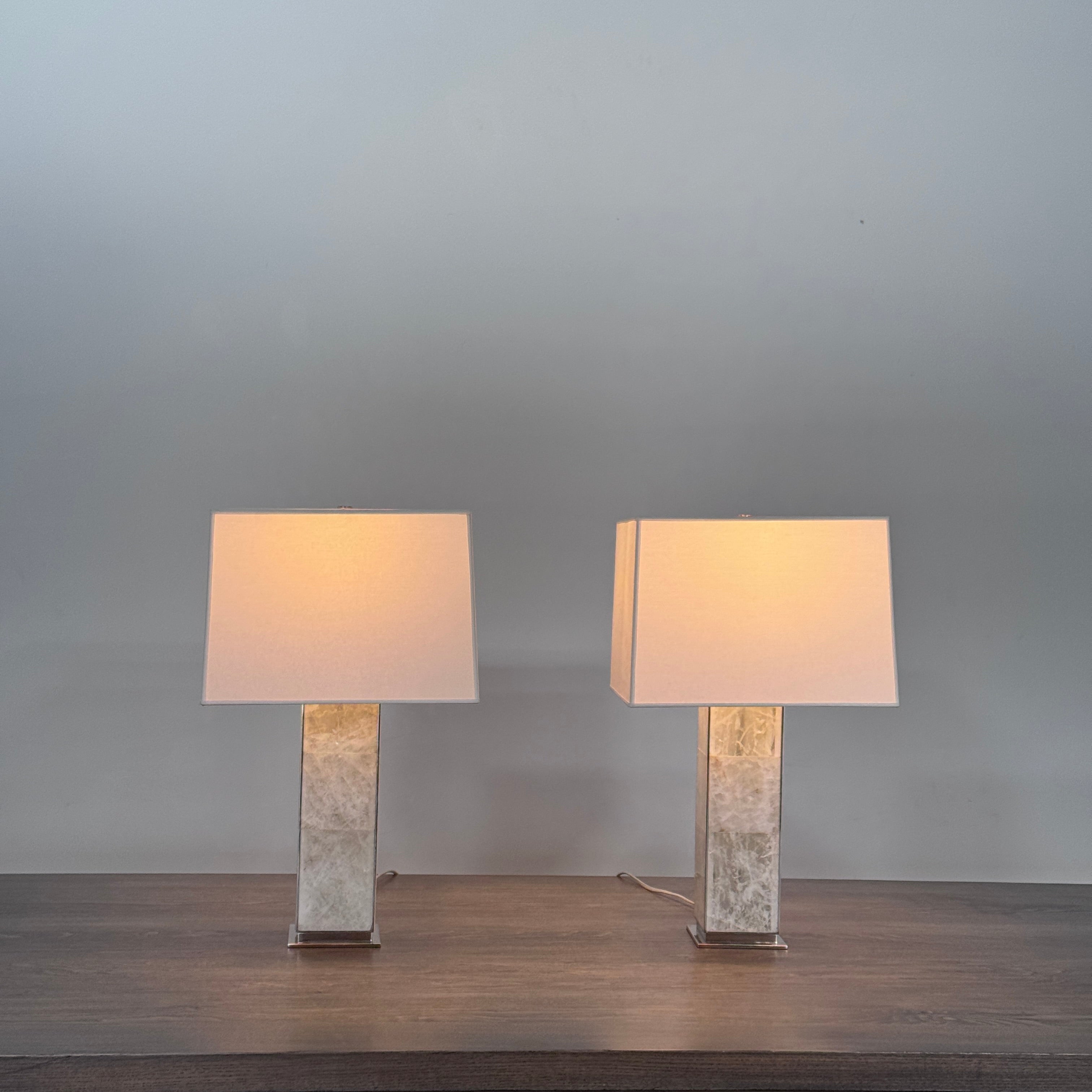 The Visual Comfort Ellis Quartz Table Lamp by Ralph Lauren features a rectangular white shade and a translucent, textured quartz base, shown against a plain white background.