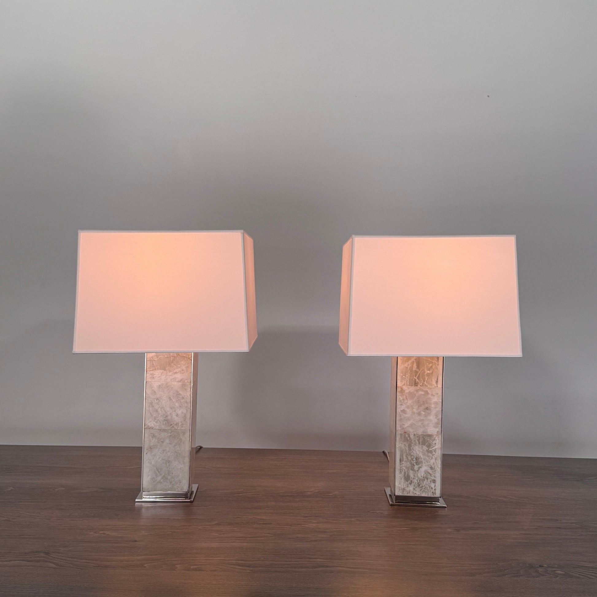 The Visual Comfort Ellis Quartz Table Lamp by Ralph Lauren features a rectangular white shade and a translucent, textured quartz base, shown against a plain white background.