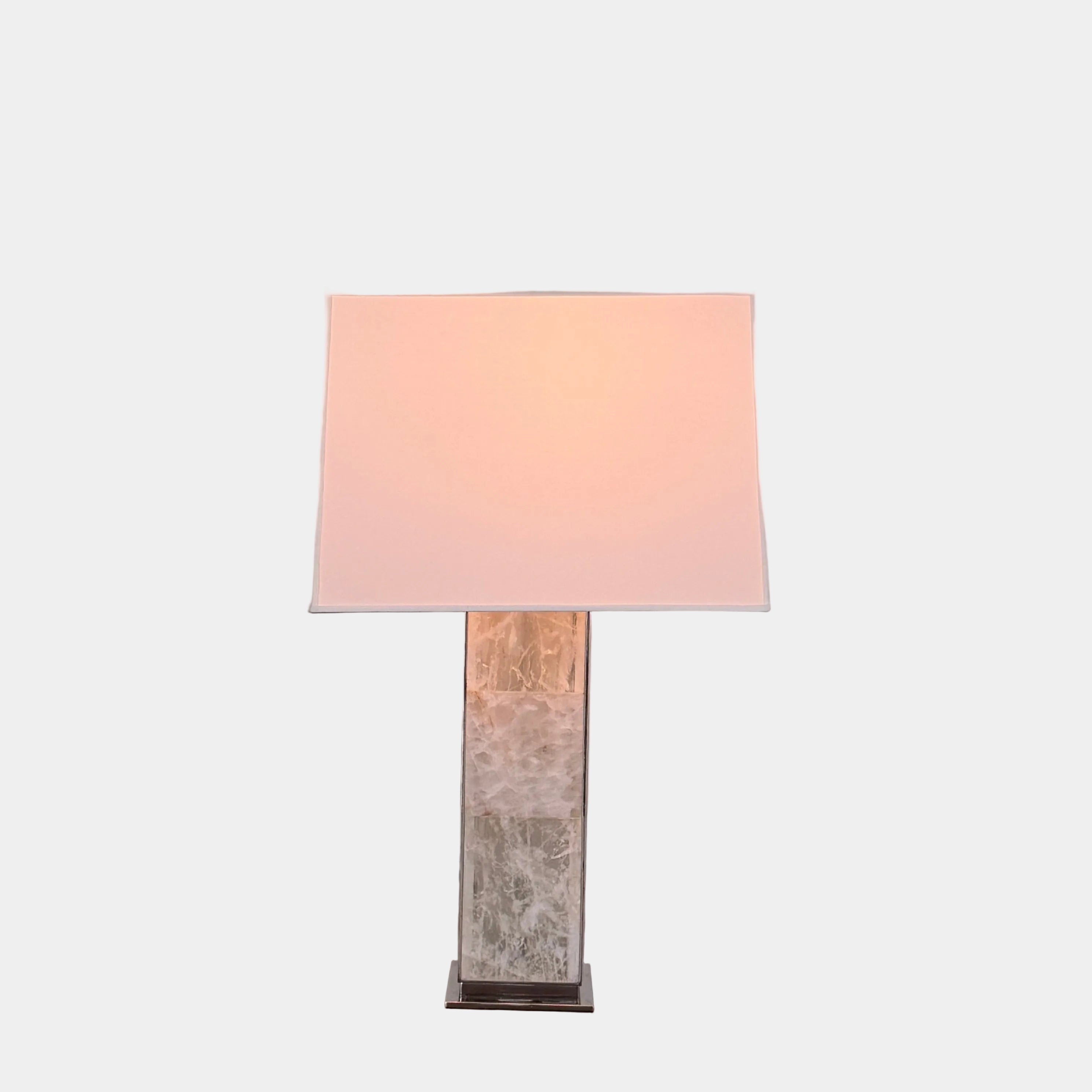 The Visual Comfort Ellis Quartz Table Lamp by Ralph Lauren features a rectangular white shade and a translucent, textured quartz base, shown against a plain white background.