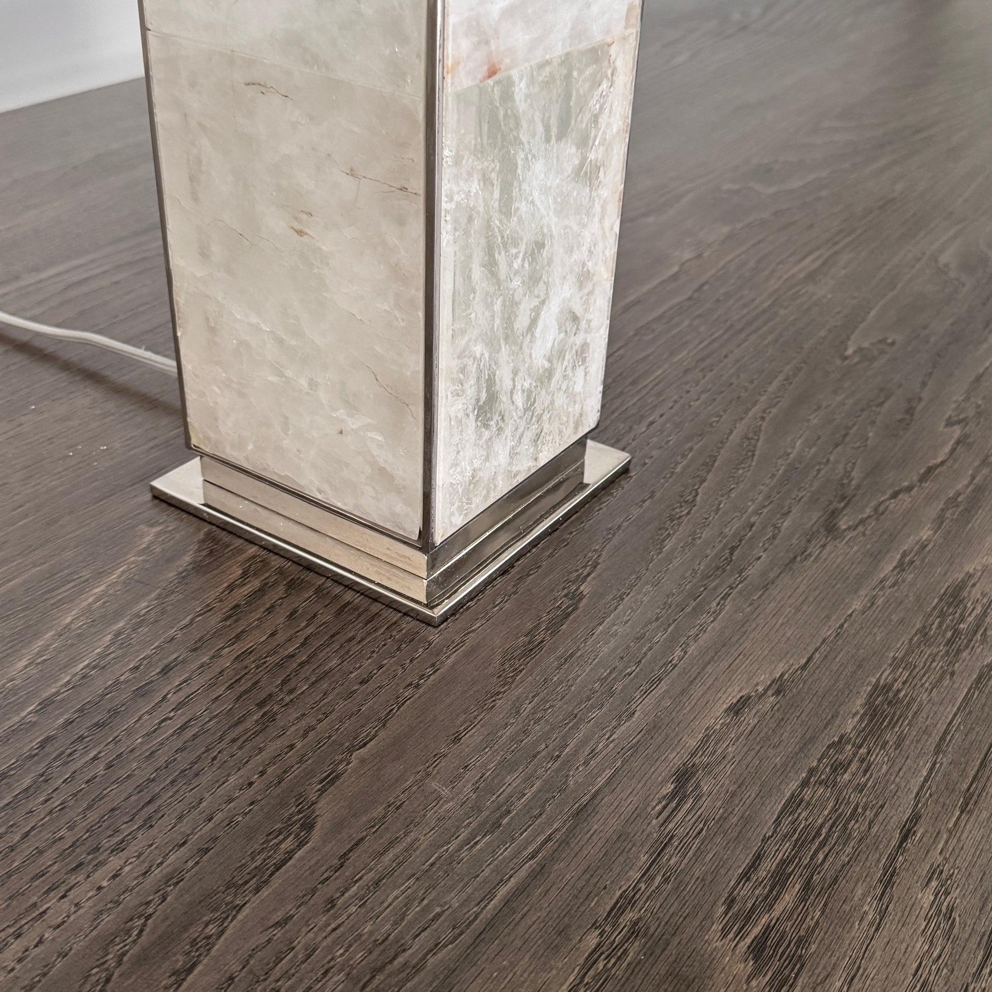 The Visual Comfort Ellis Quartz Table Lamp by Ralph Lauren features a rectangular white shade and a translucent, textured quartz base, shown against a plain white background.