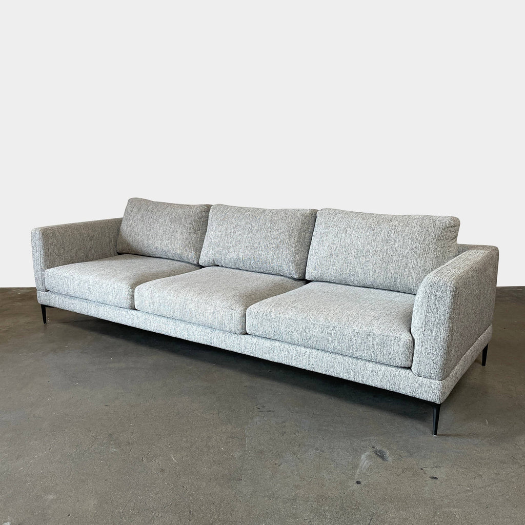A Della Robia sectional sofa with a chaise and ottoman.