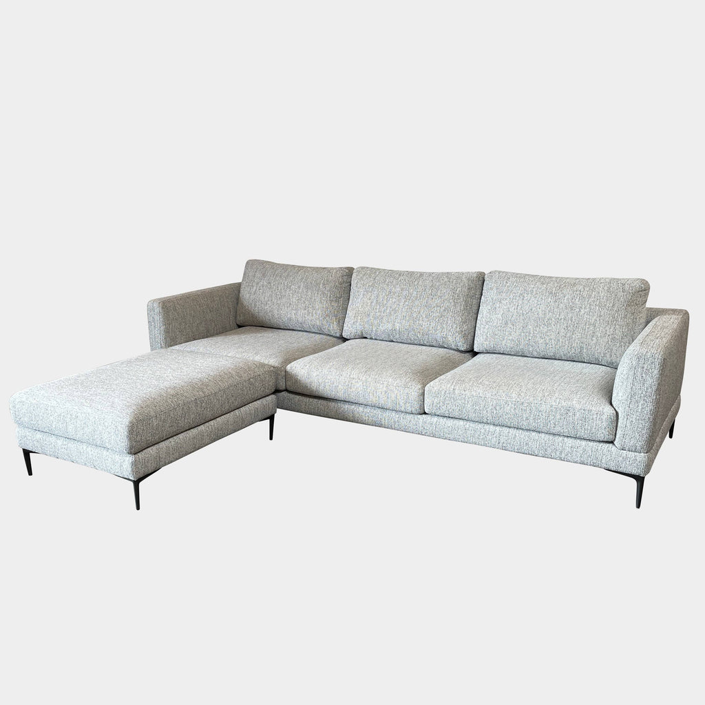 A Della Robia sectional sofa with a chaise and ottoman.