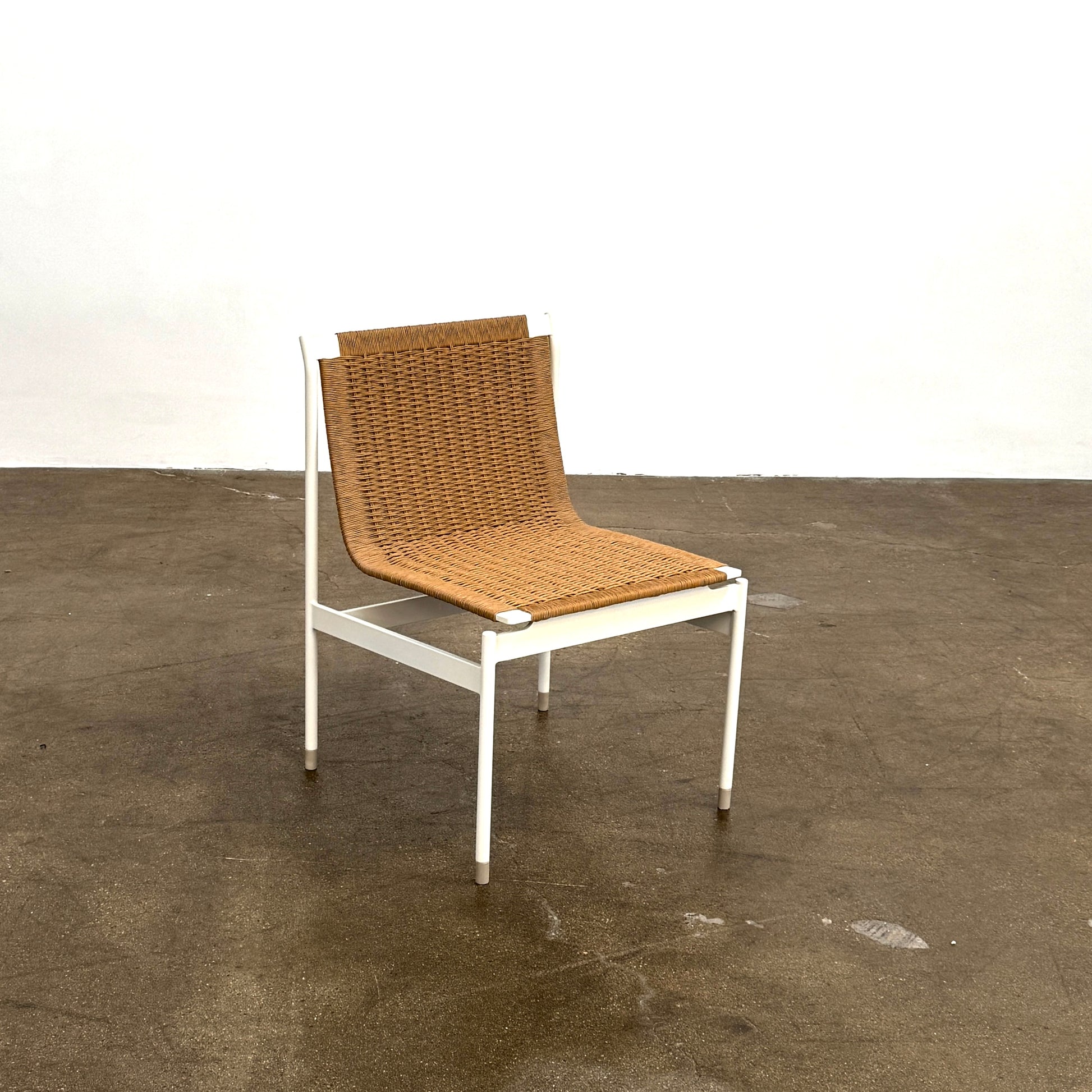 Nine MillerKnoll Sommer Outdoor Dining Chairs for DWR, sold in sets of 2, with metal frames and weatherproof wicker seats and backs, are arranged in three rows against a plain white background.