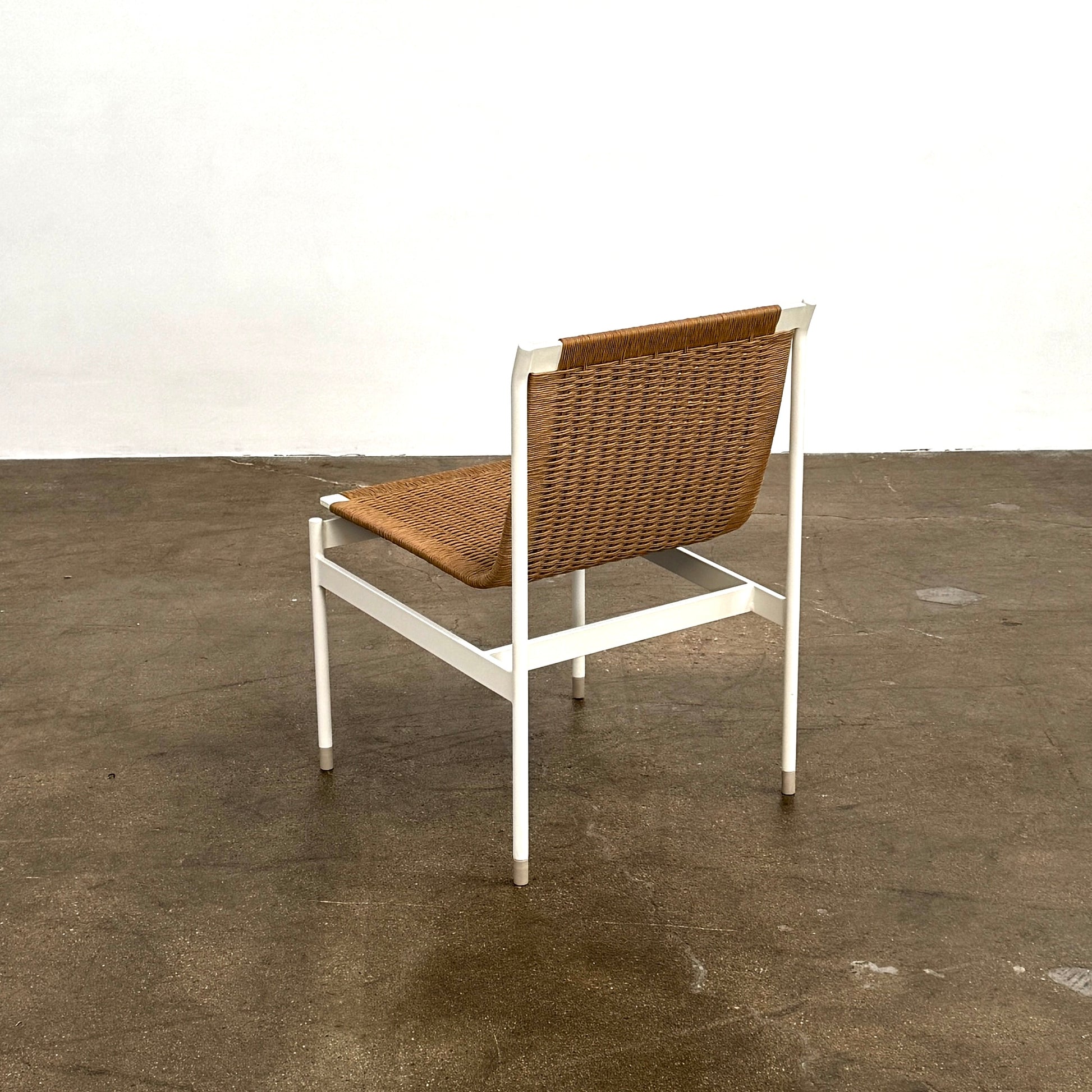 Nine MillerKnoll Sommer Outdoor Dining Chairs for DWR, sold in sets of 2, with metal frames and weatherproof wicker seats and backs, are arranged in three rows against a plain white background.