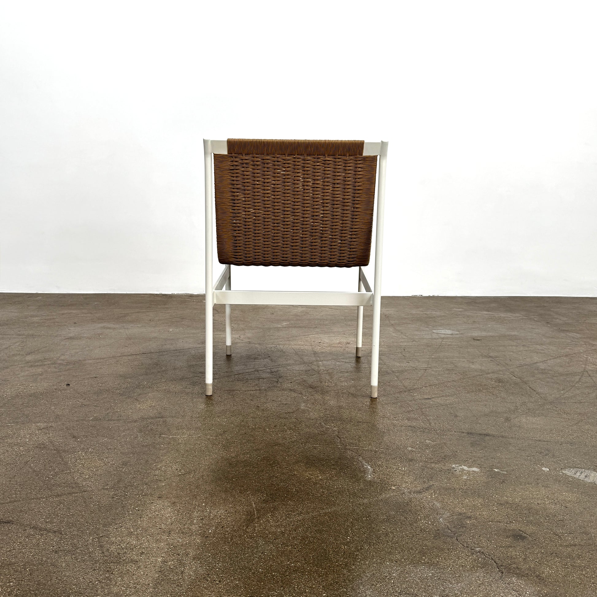 Nine MillerKnoll Sommer Outdoor Dining Chairs for DWR, sold in sets of 2, with metal frames and weatherproof wicker seats and backs, are arranged in three rows against a plain white background.