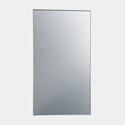 The DWR Mondrian Wall Hanging Mirror (44" x 80") by DWR features a sleek, minimalist rectangular design with a thin, dark frame and stands upright against a plain white backdrop for a modern look.
