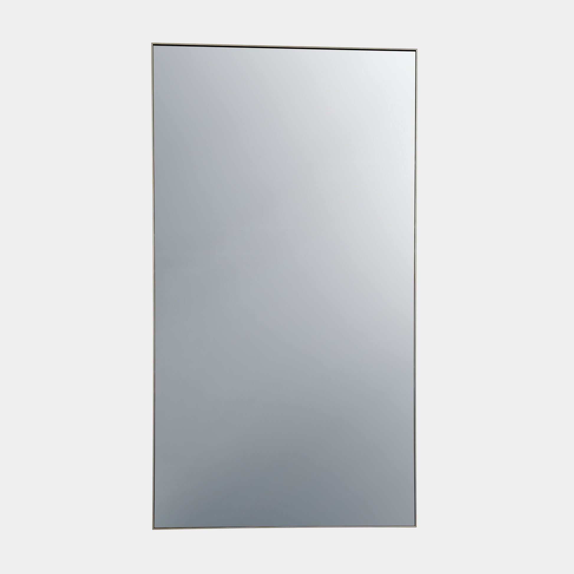 The DWR Mondrian Wall Hanging Mirror (44" x 80") by DWR features a sleek, minimalist rectangular design with a thin, dark frame and stands upright against a plain white backdrop for a modern look.