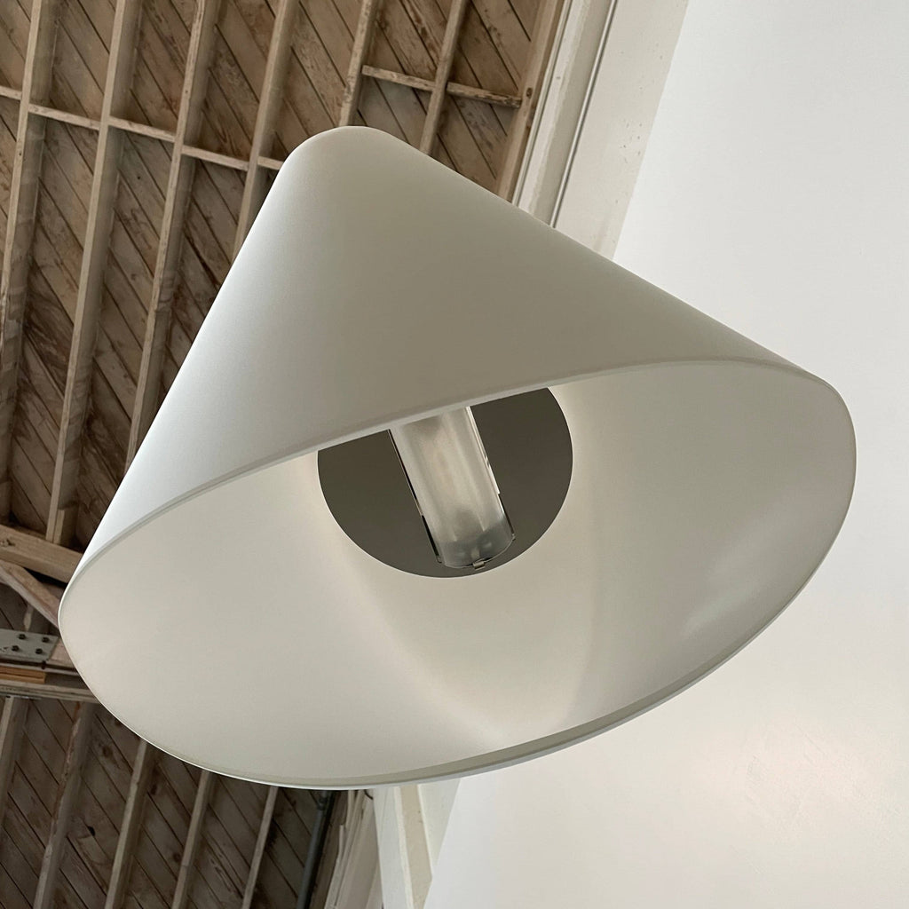 A modern Foscarini Cross Ceiling Light with a minimalist white shade suspended from the ceiling by two wires against a white background.