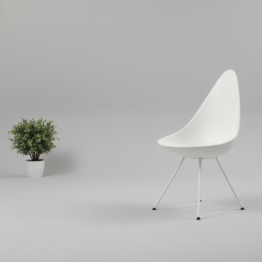 The Fritz Hansen Drop Chair Set of 4 by Fritz Hansen features white modernist chairs with teardrop-shaped backs and slender metal legs, inspired by the iconic Arne Jacobsen design, arranged in a staggered formation on a plain background.