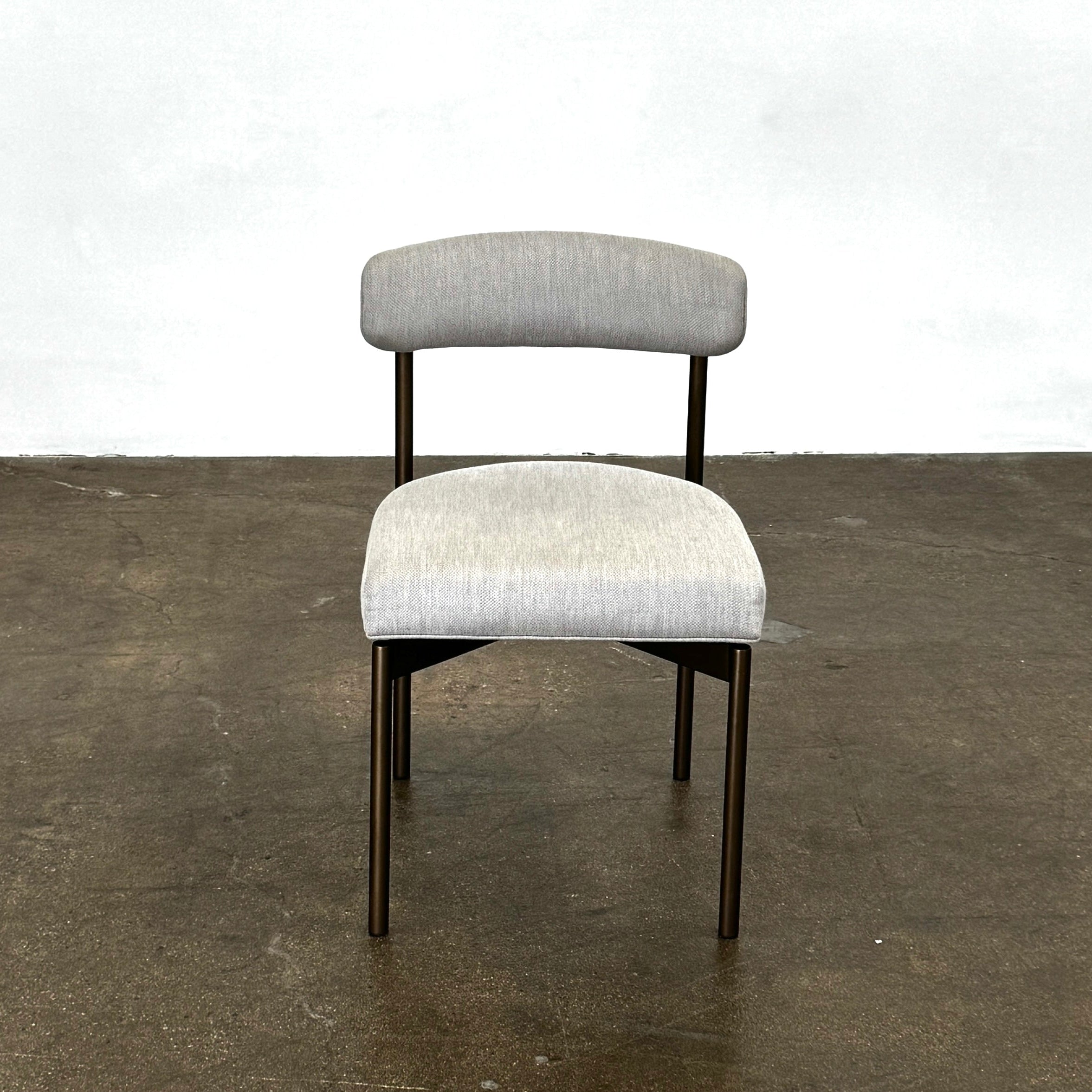 Five Mitchell Gold + Bob Williams Remy dining chairs, upholstered in high-performance fabric with dark metal legs, are arranged in two rows on a plain white background.