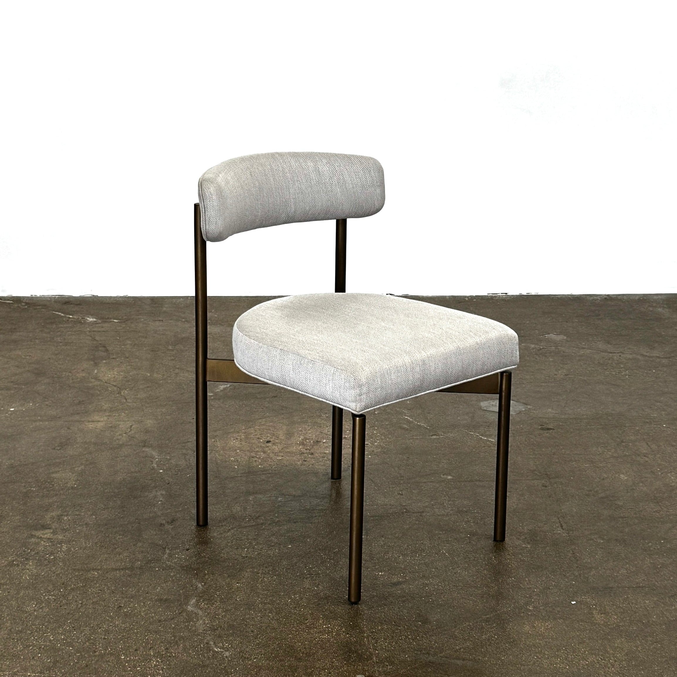 Set of six Mitchell Gold + Bob Williams Remy dining chairs with light beige upholstered seats and backs, dark wooden legs and frames, arranged in two rows against a plain light background.