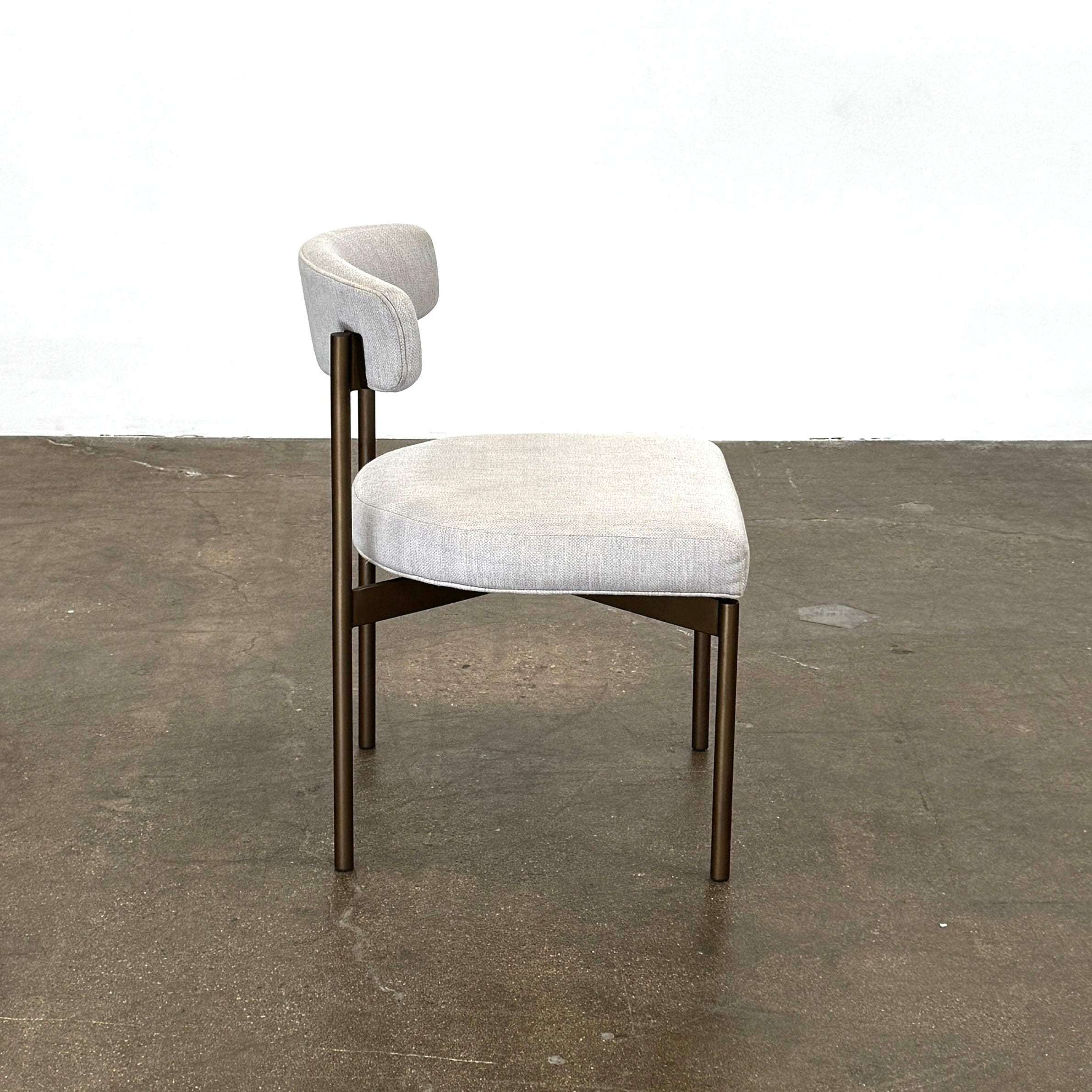Five Mitchell Gold + Bob Williams Remy dining chairs, upholstered in high-performance fabric with dark metal legs, are arranged in two rows on a plain white background.