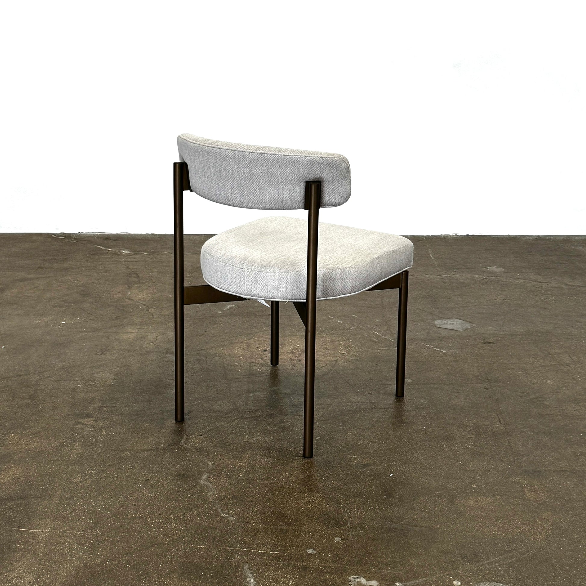 Set of six Mitchell Gold + Bob Williams Remy dining chairs with light beige upholstered seats and backs, dark wooden legs and frames, arranged in two rows against a plain light background.